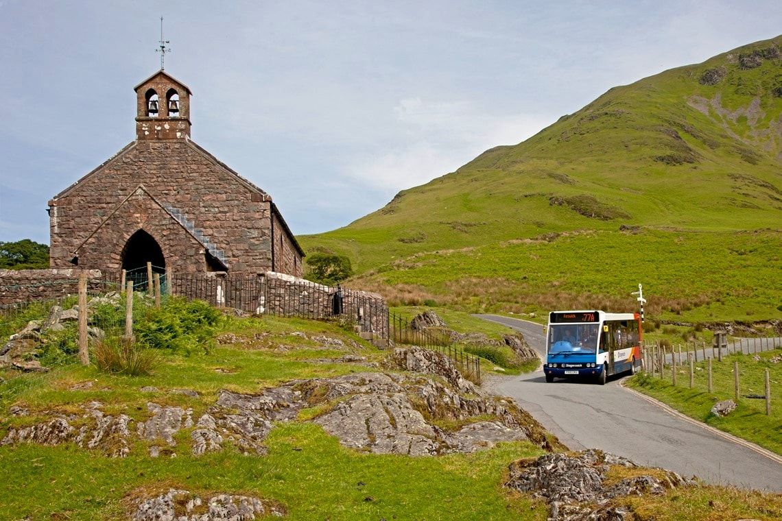 Honister Rambler bus passing Buttermere church