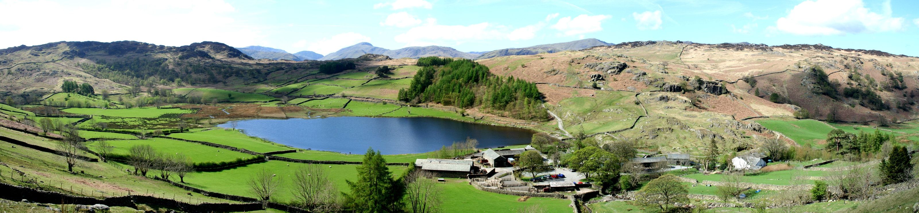 Watendlath Tarn lying among walled fields high in the fells