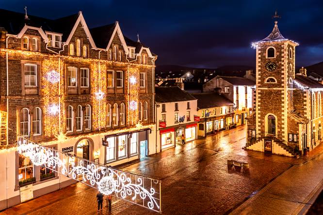 The Moot Hall clock tower above a busy Keswick market street