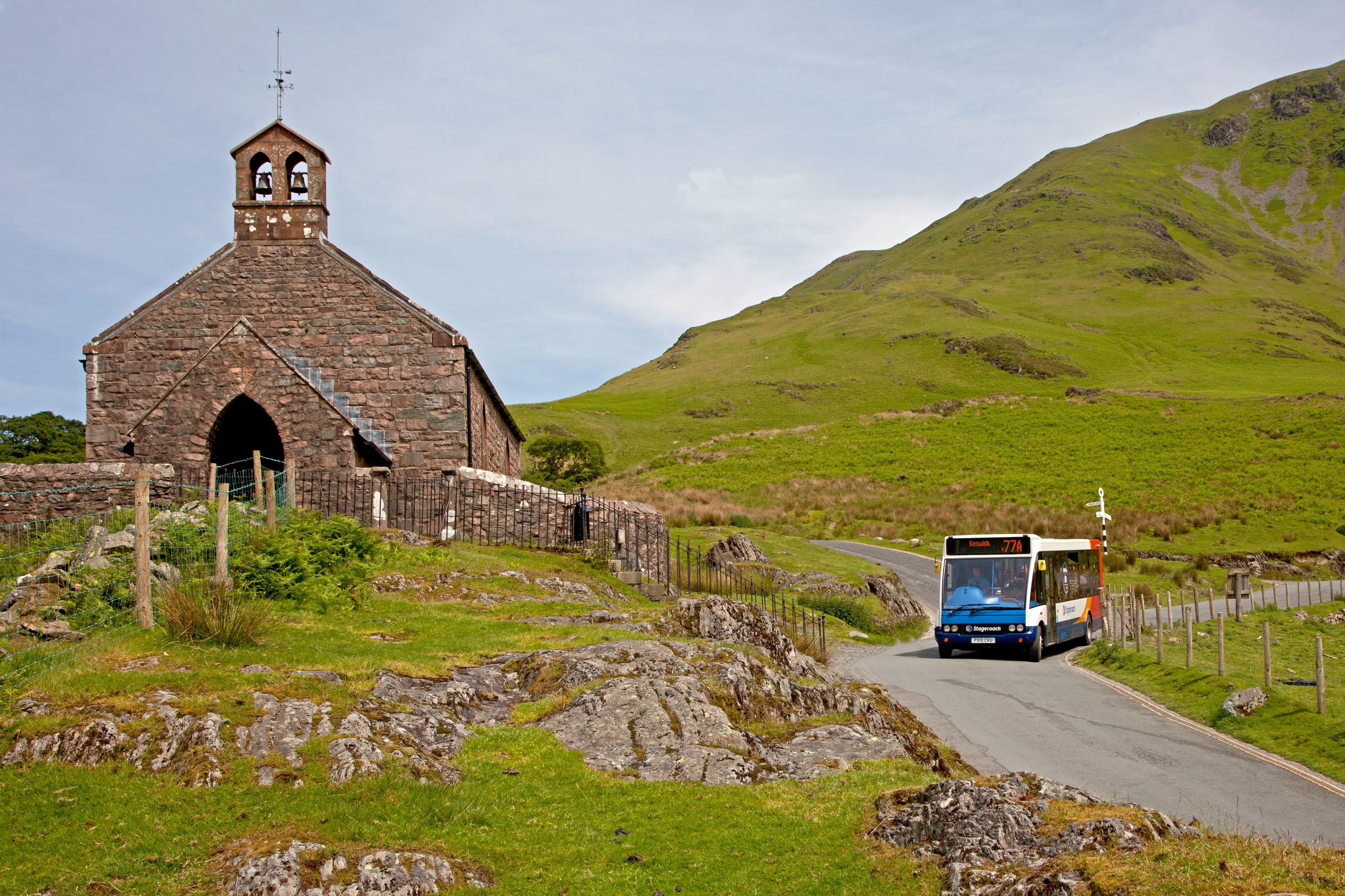 The small stone church with its bellcote standing on a rocky knoll above the valley road