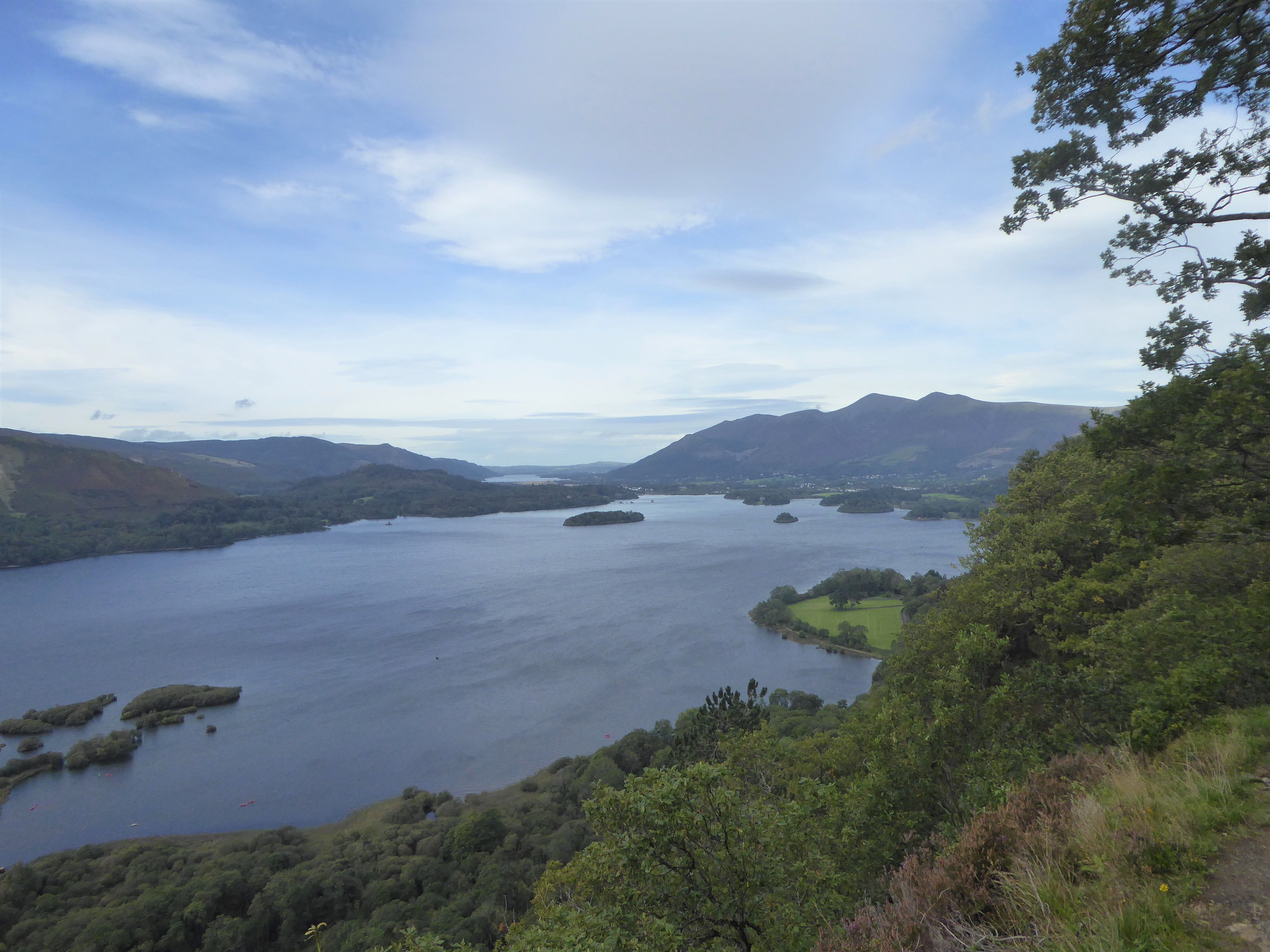 Derwentwater and the vale seen from the viewpoint above Ashness with a walker looking on