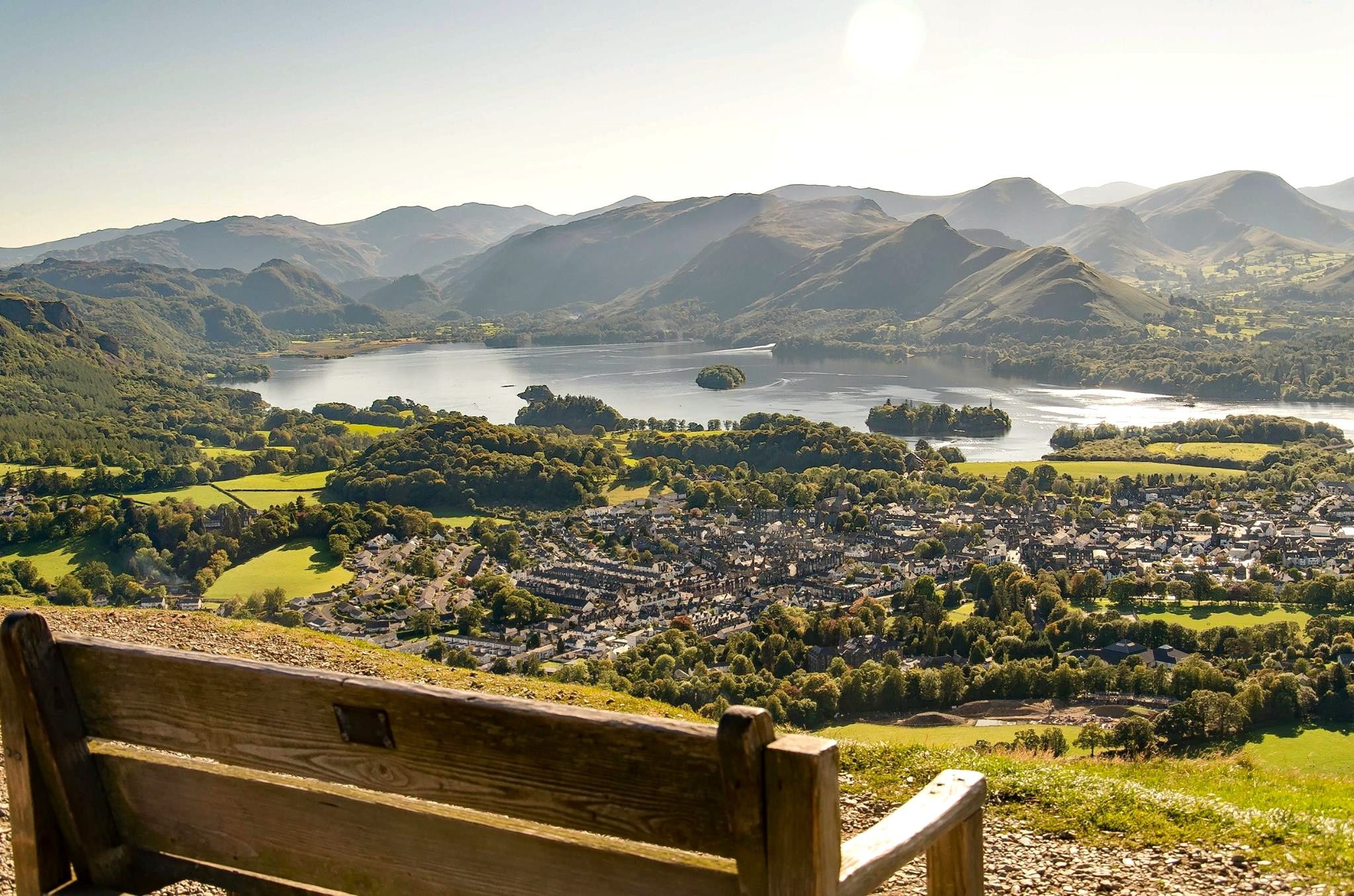 A wooden gate at the summit path with Keswick and the lake laid out below
