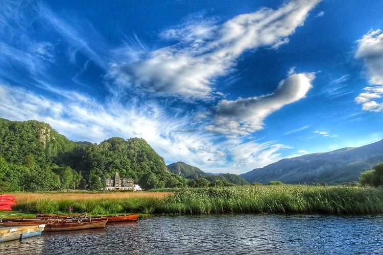 Wooden rowing boats drawn up among the reeds at the lake edge