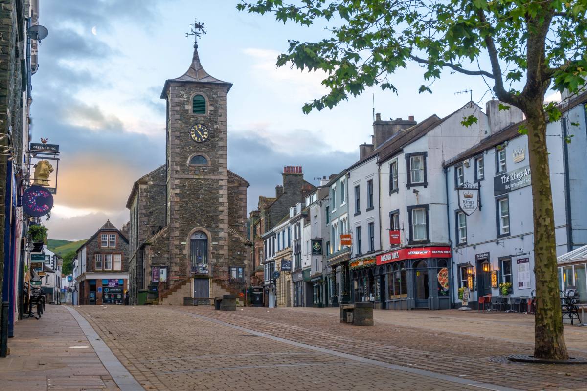 The Moot Hall clock tower above a busy Keswick market street