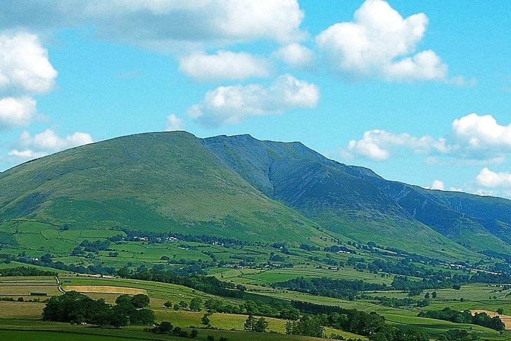 The green flanks and gullies of Blencathra seen across the vale from the south
