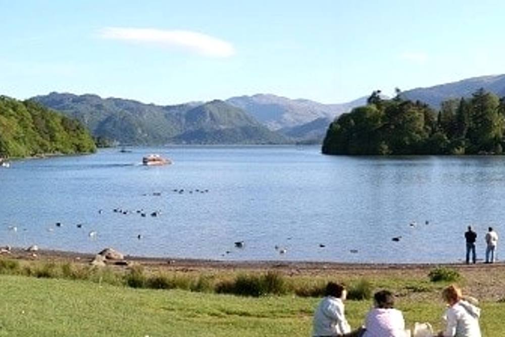 People enjoying the view over Derwentwater in Crow Park