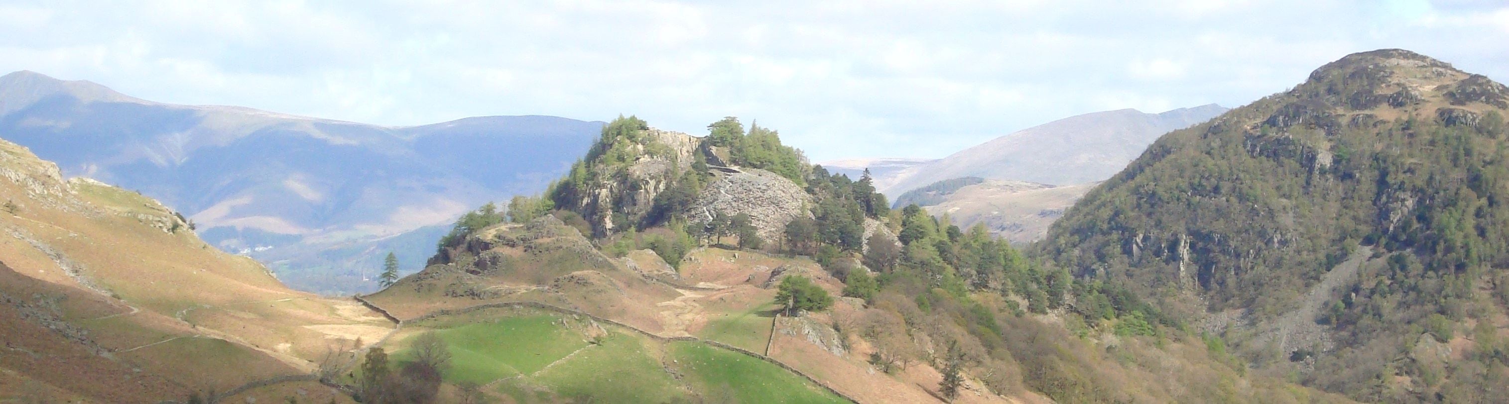 The wooded knoll of Castle Crag standing in the jaws of Borrowdale