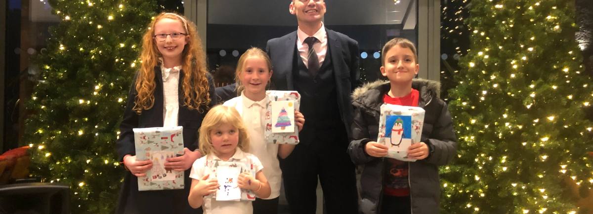 Christmas card competition winners alongside Marcell Cilliers, General Manager of the Lodore Falls Hotel & Spa