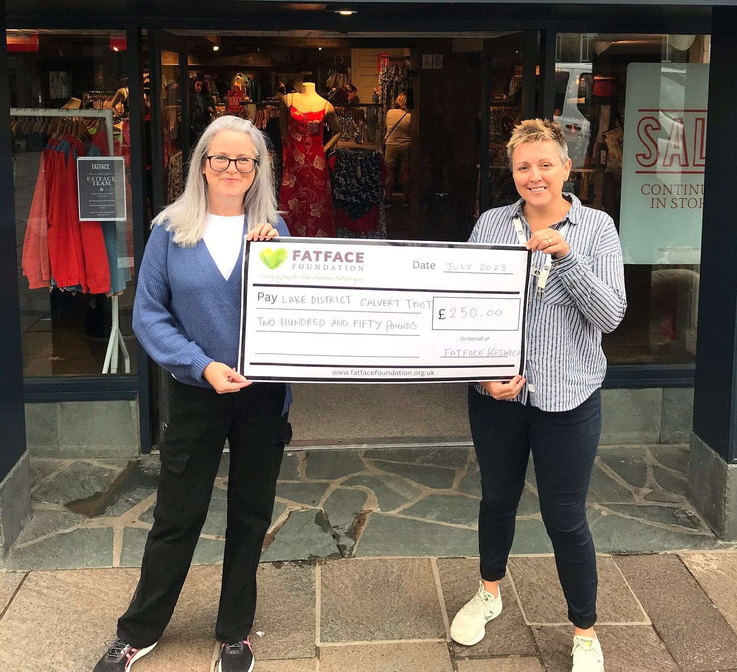 Louise Dunn, Calvert Lakes Trustee (L) accepting a presentation cheque from Natalie Barry (R)