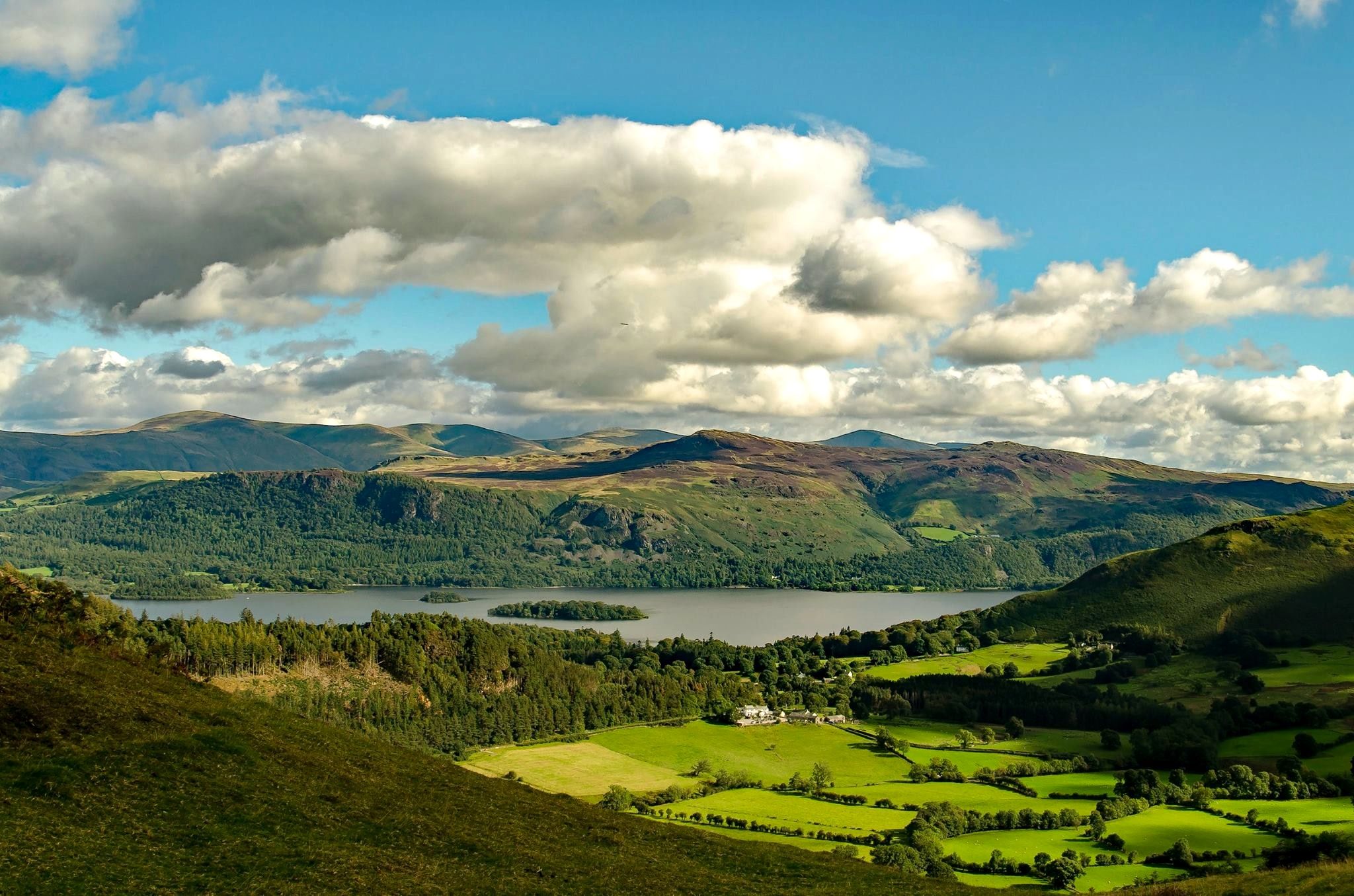 Derwentwater and the wooded vale seen from high on Barrow under piled cloud