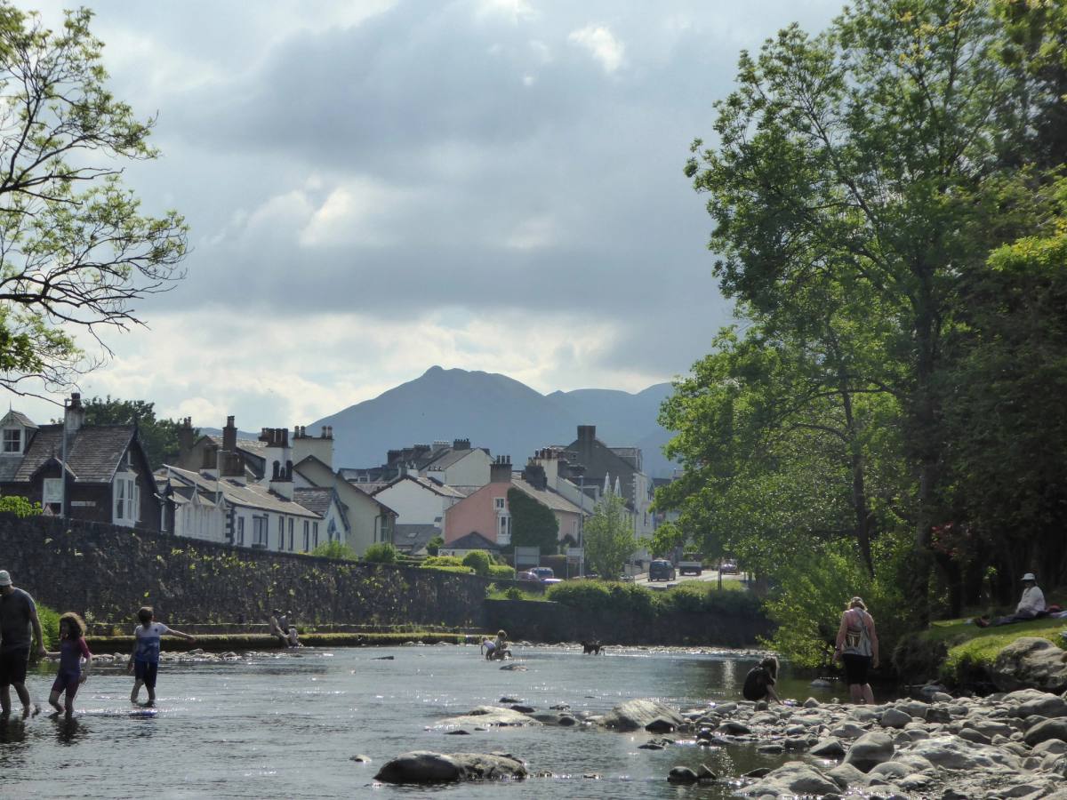 The rooftops of Keswick seen across the river with the fells rising behind