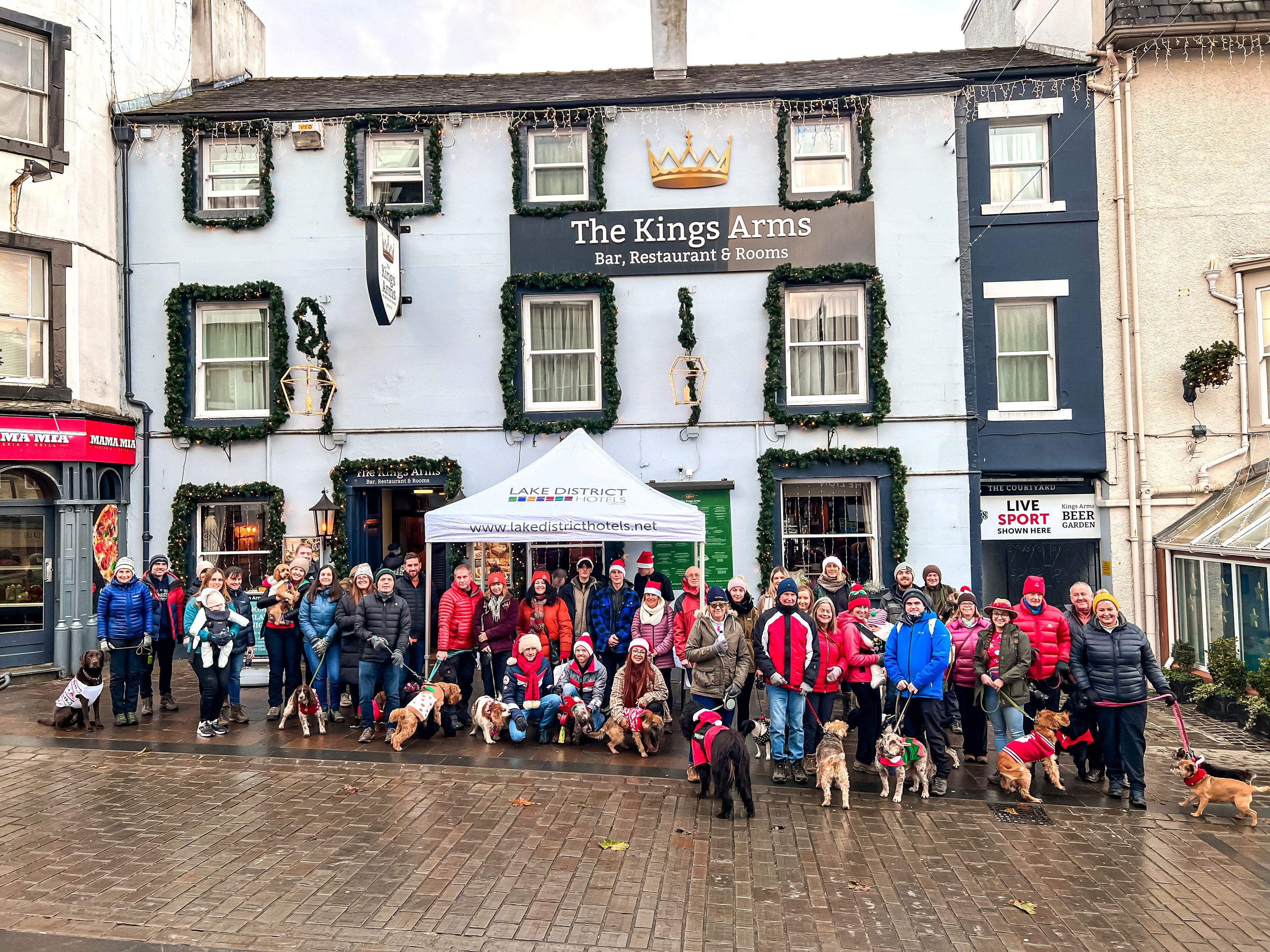 Dogs and owners outside the Kings Arms in Keswick before the charity dog walk