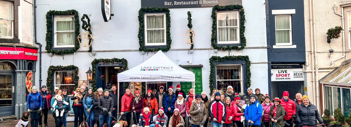 Dogs and owners outside the Kings Arms in Keswick before the charity dog walk