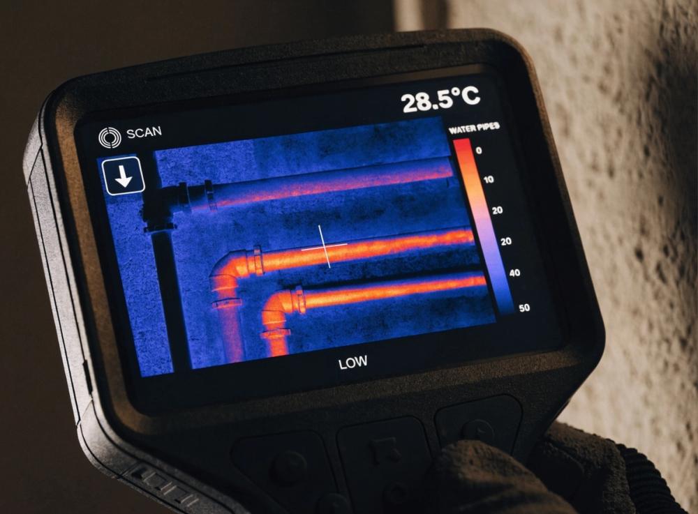Thermal imaging camera showing pipe heat signature