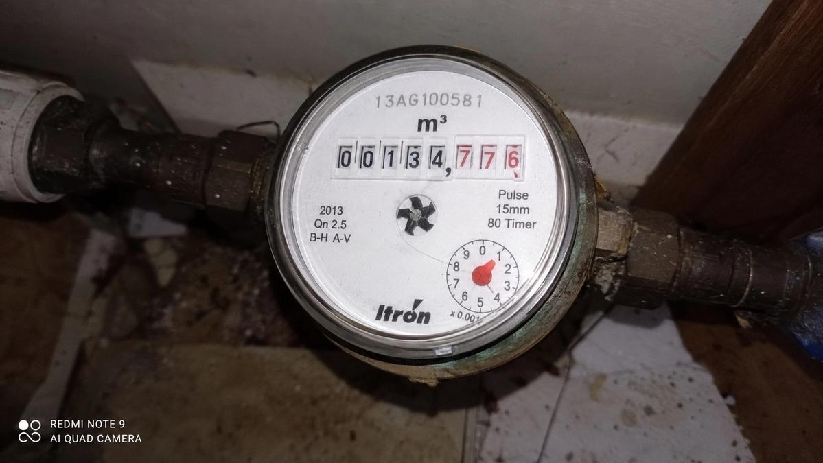 Itron water meter mid-reading in a UK home, checked during a leak investigation
