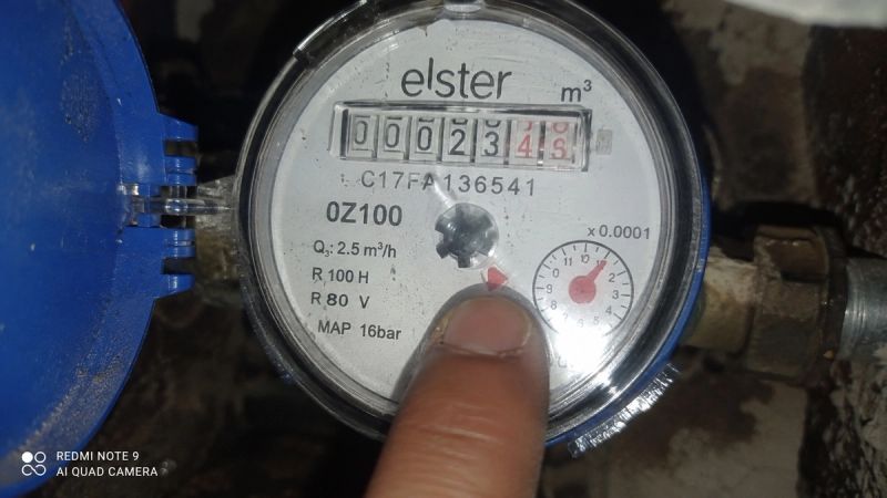 Close-up of a water meter dial with leak indicator turning during a leak check