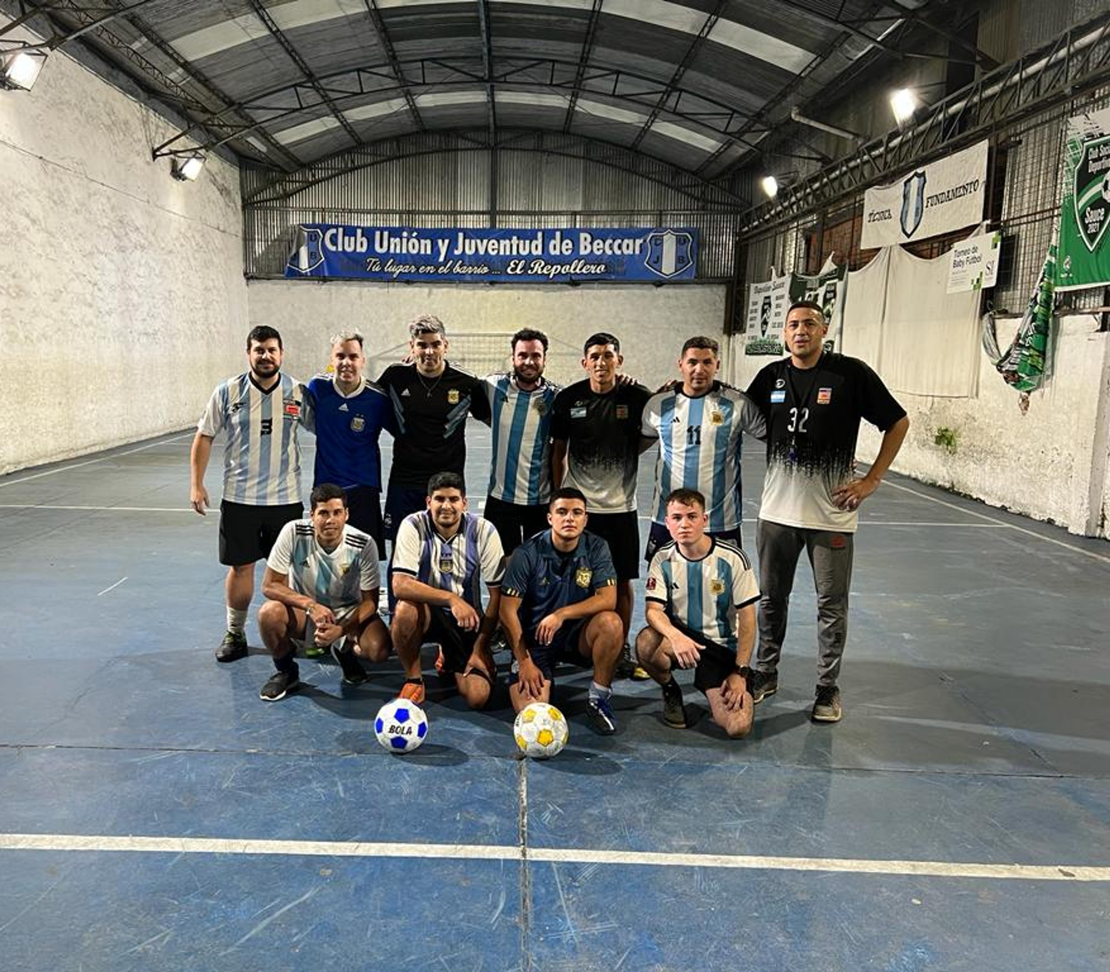 The Argentinian street soccer team pose for a squad photo at an indoor soccer oitch