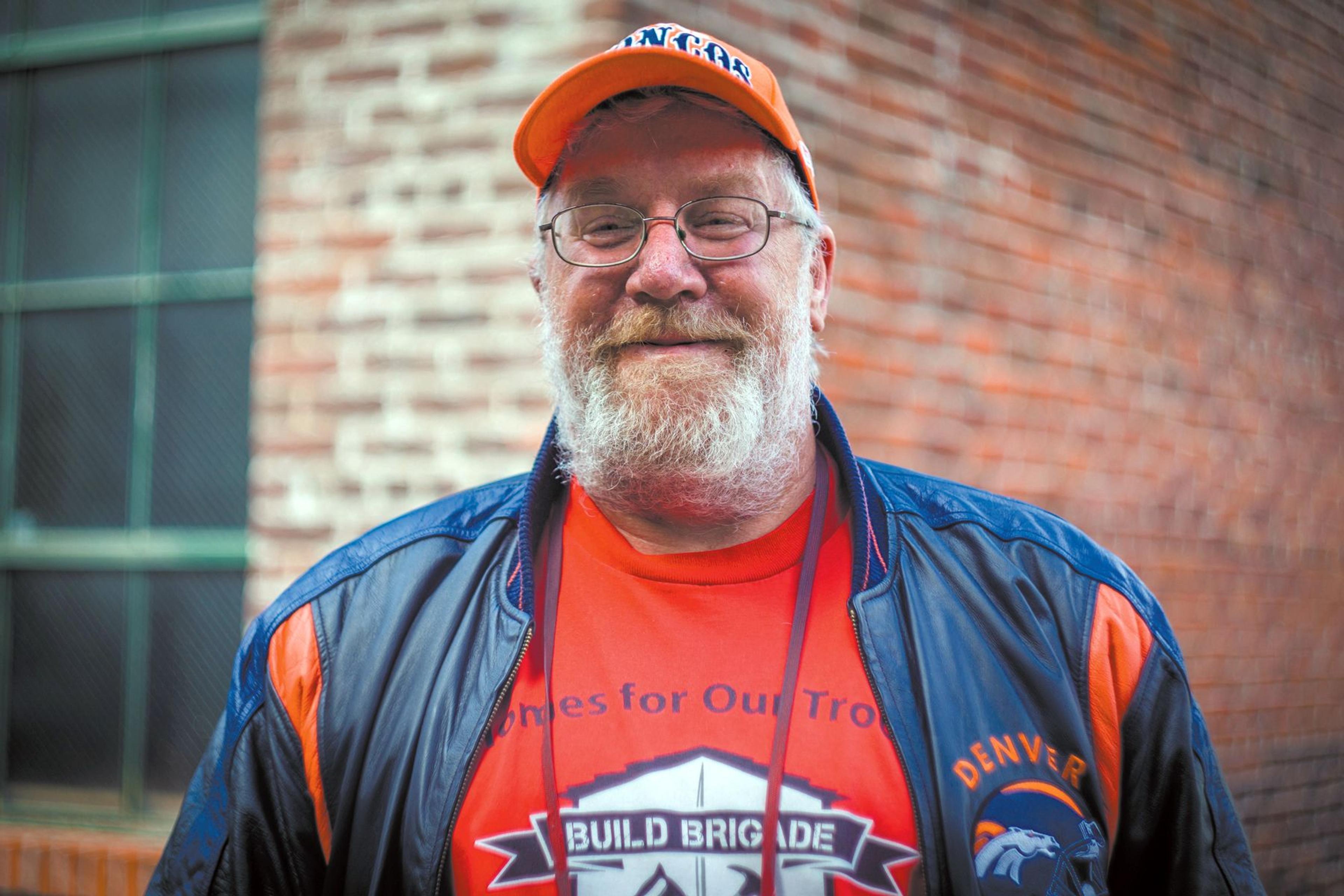 Man in orange cap and glasses