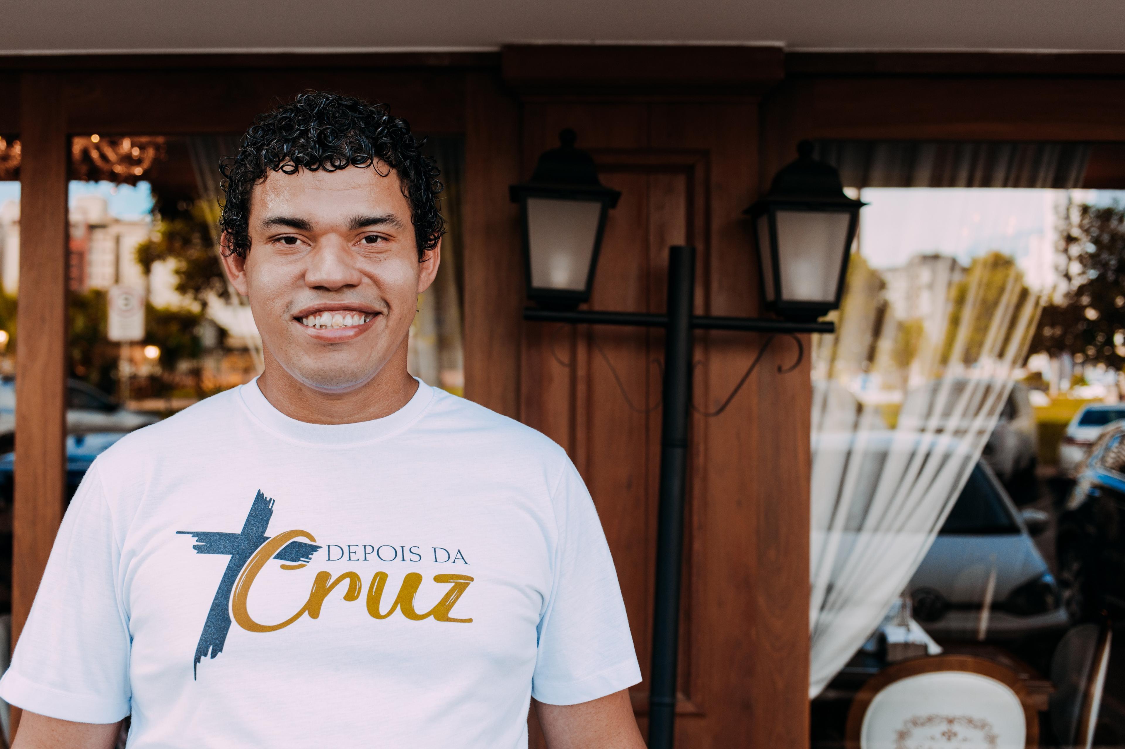 Man smiling in front of windows