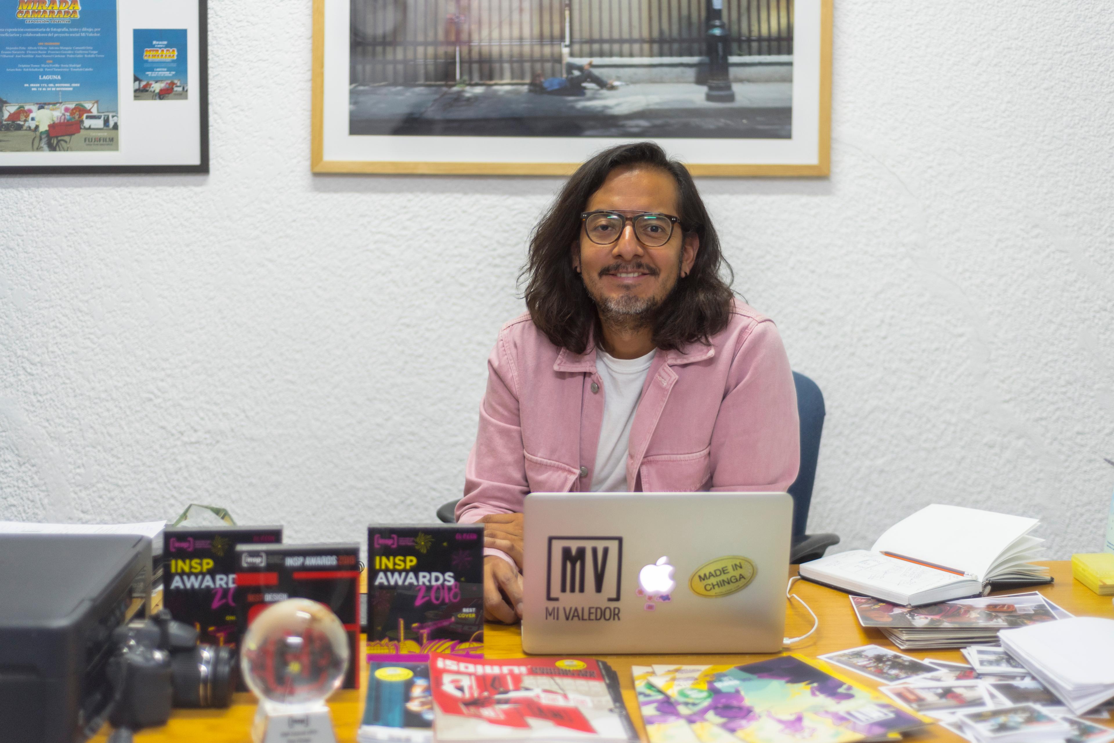 Arturo Soto, a photojournalist with Mi Valedor, sitting at his desk