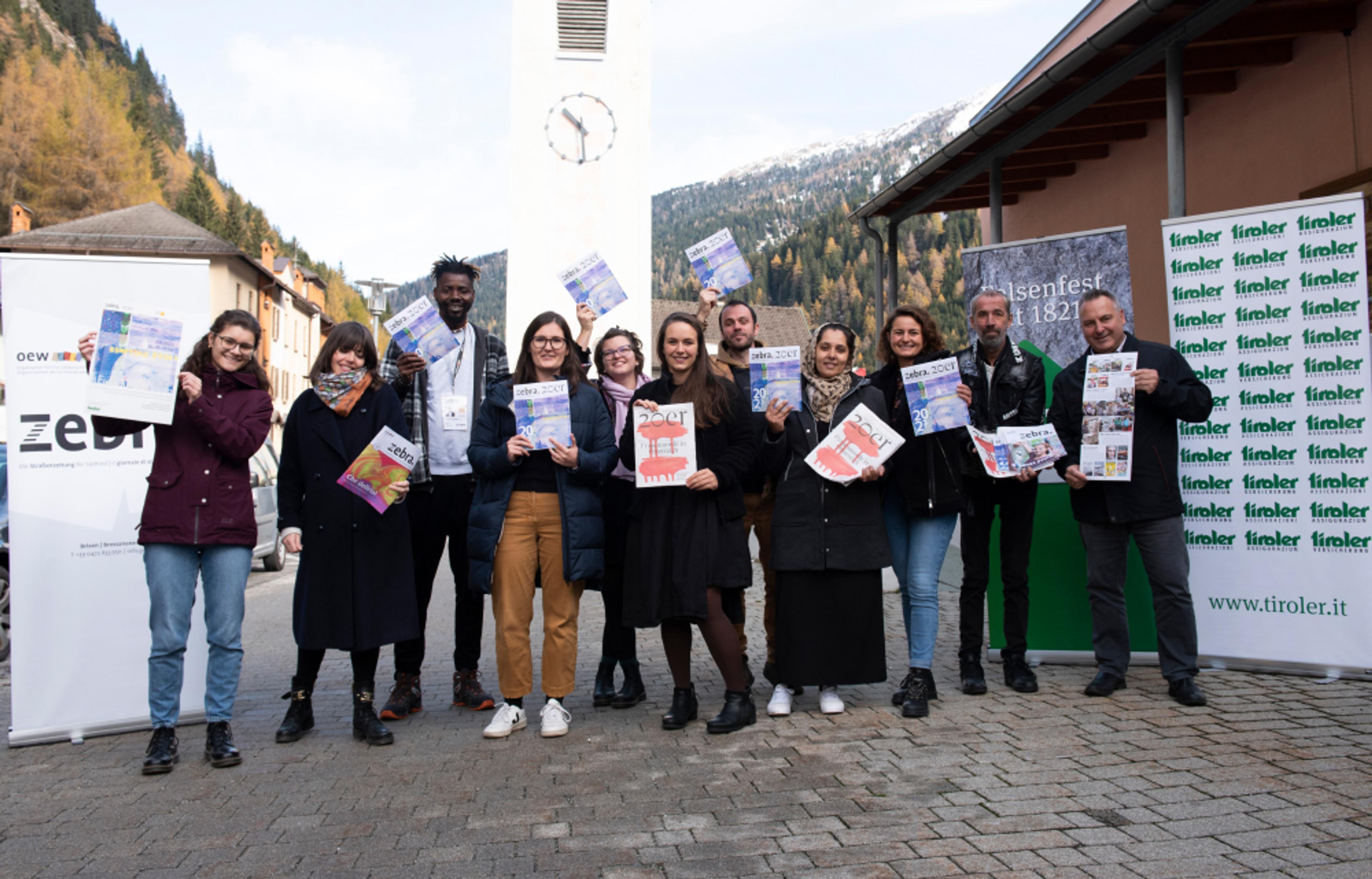 Members of the 20er and zebra. street paper teams pose with their new collaborative calendar