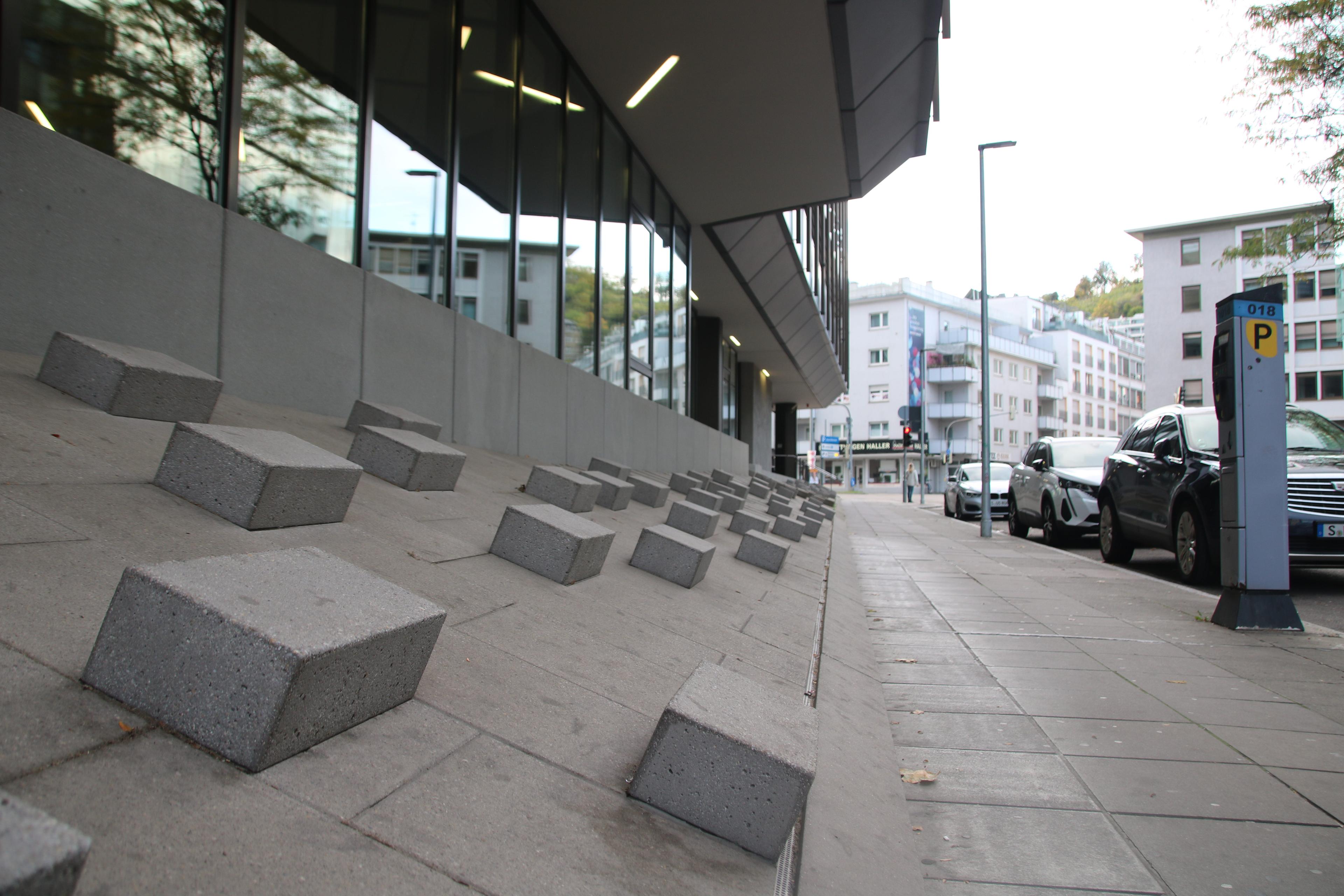 An example of bollards on a sloped part of a pedestrian street being used as anti-homeless architecture