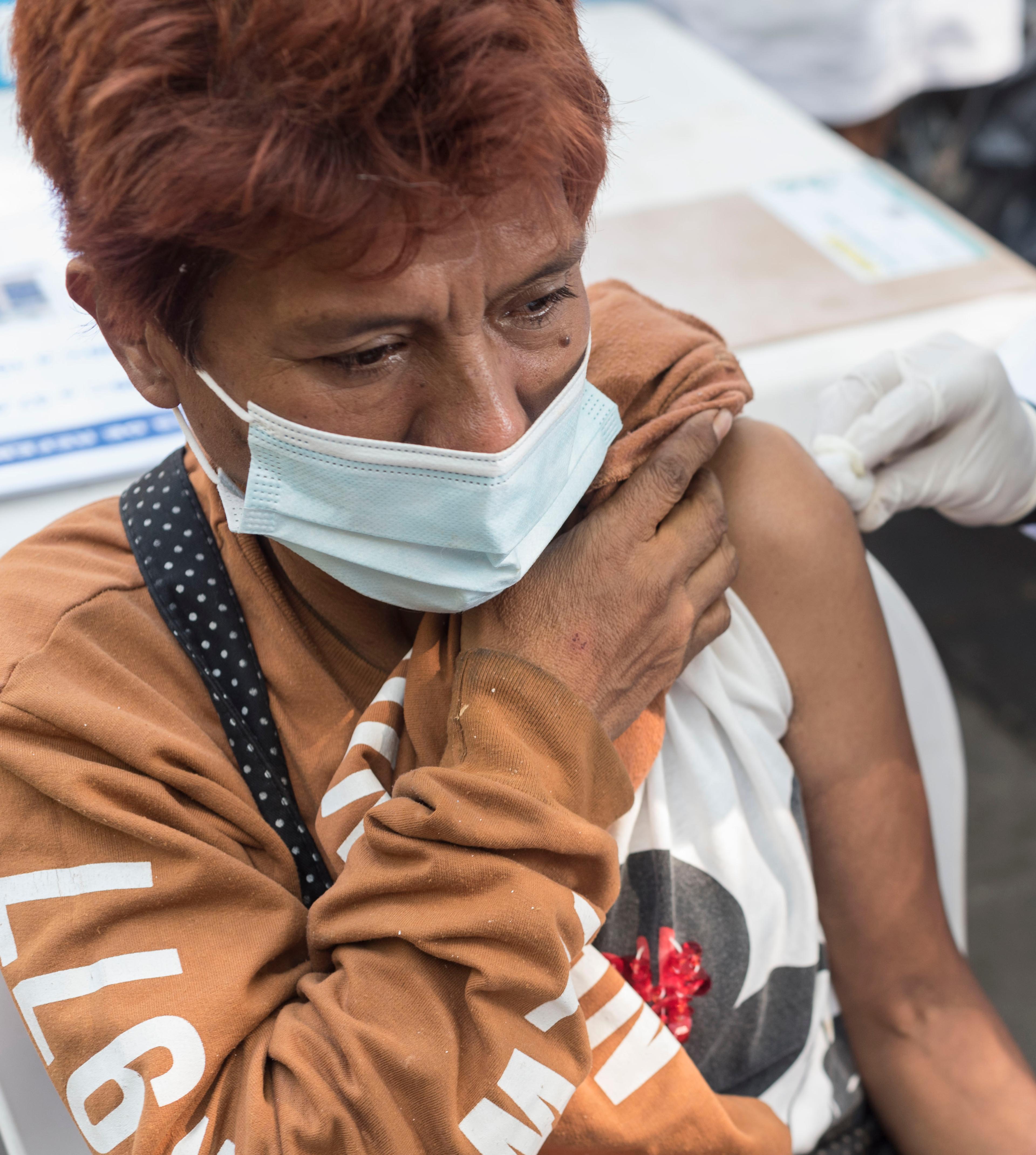 A woman gives out medical supplies in Mexico City