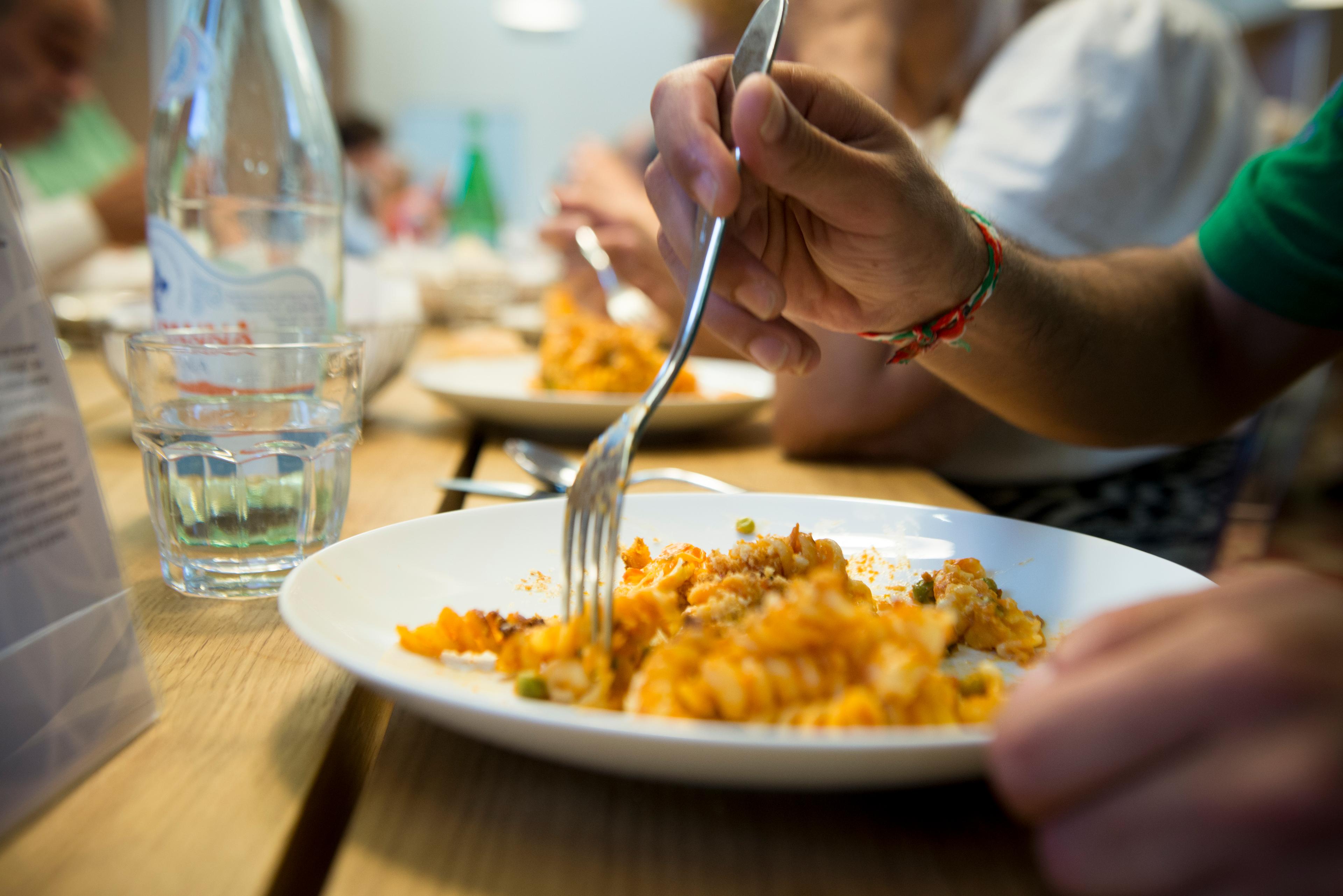 A person eating pasta