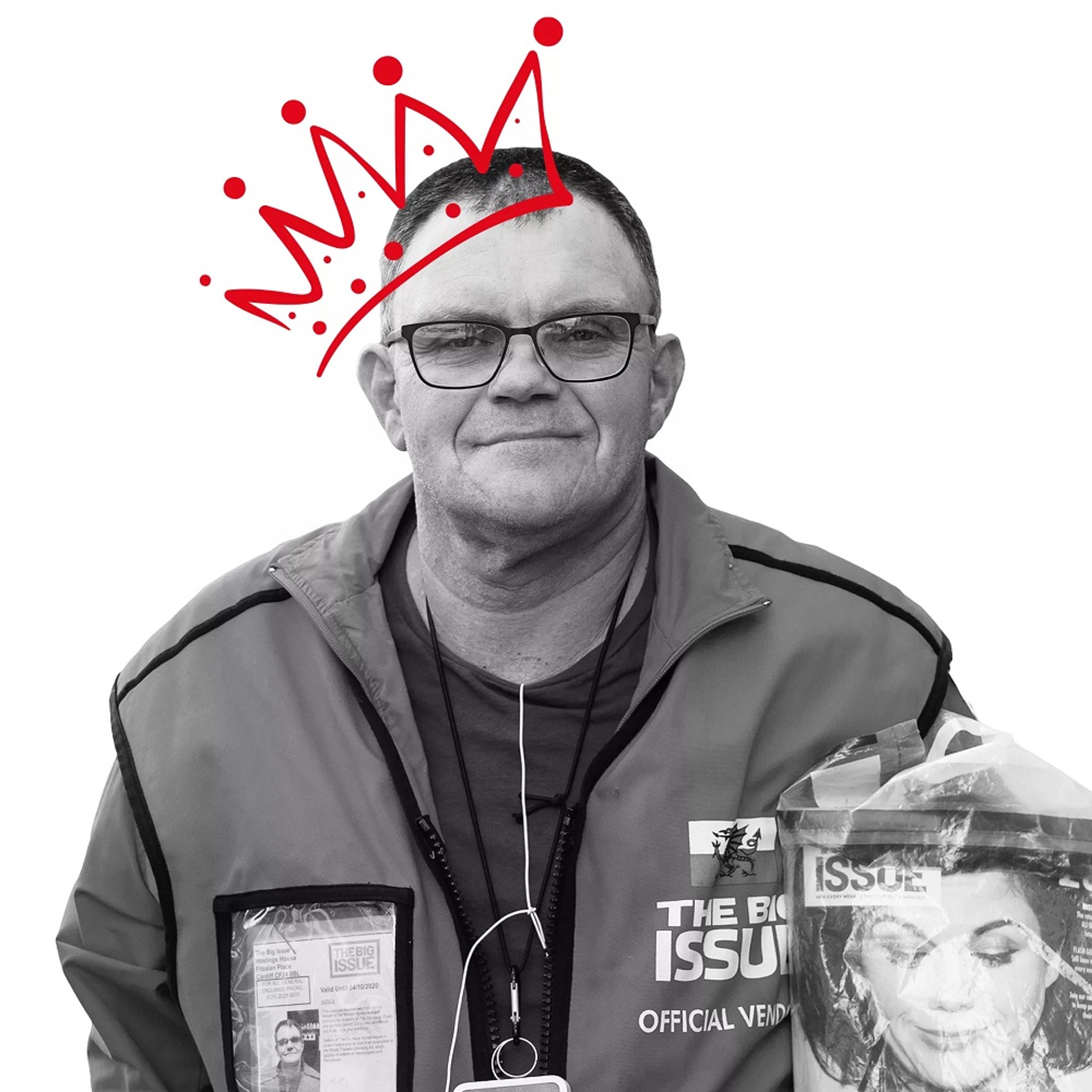 Black and white photo of man with magazine and crown