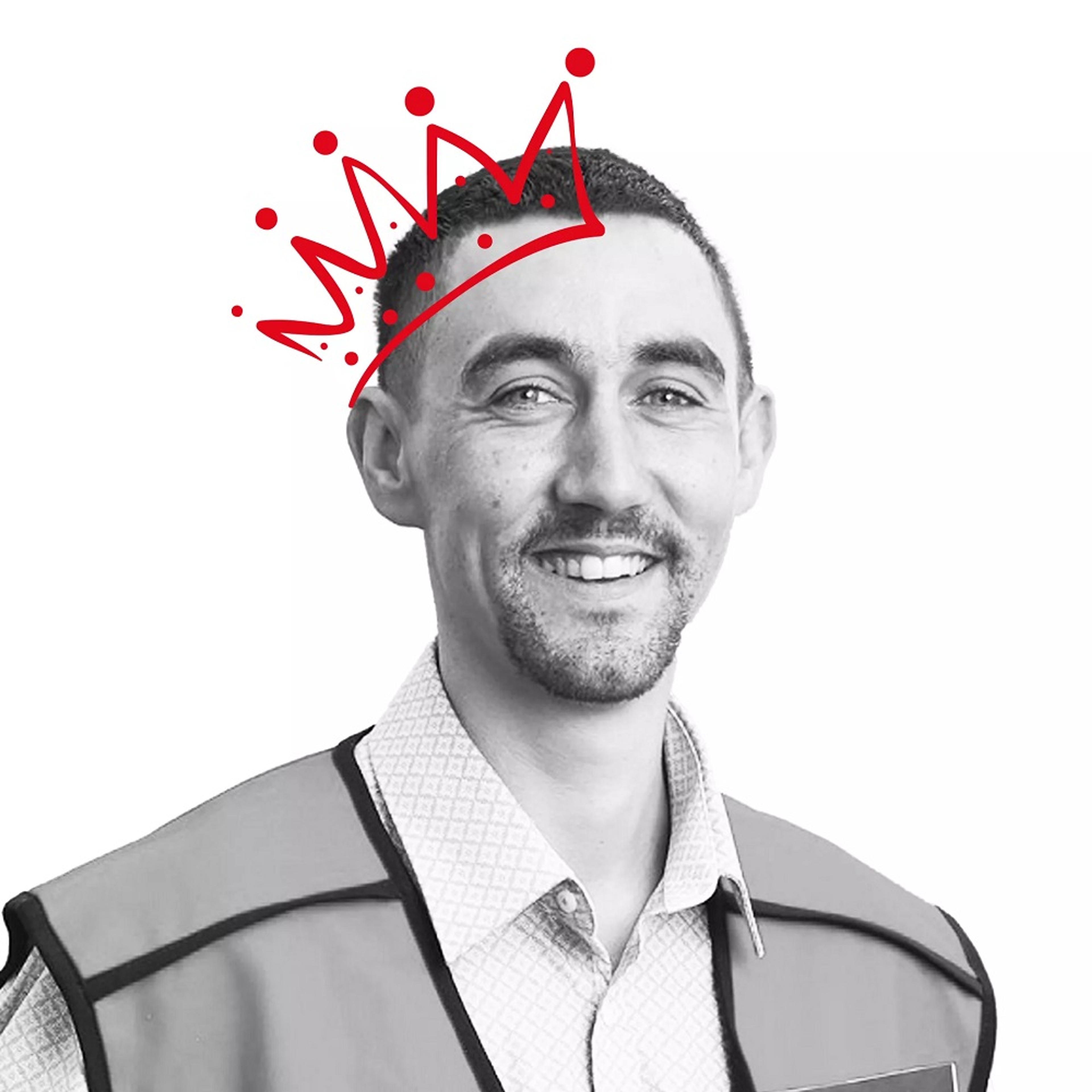 Black and white image of man with red crown