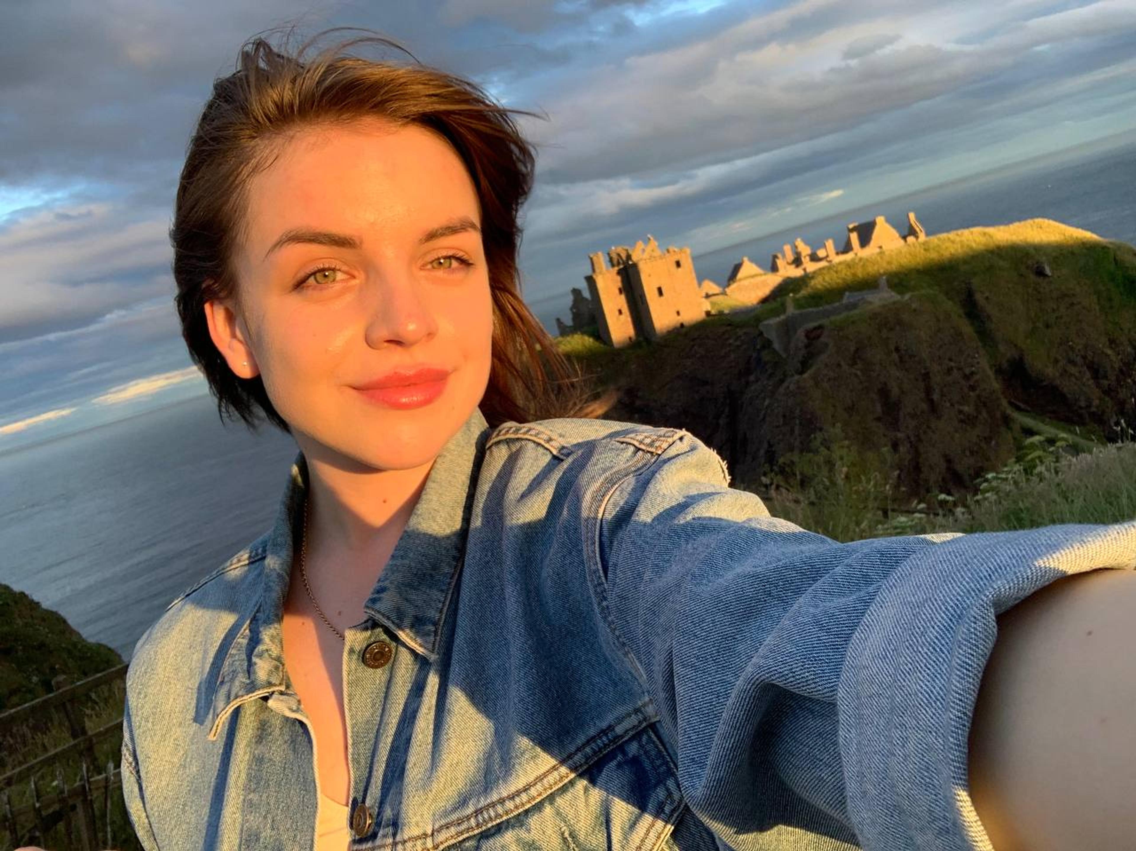 A woman taking a selfie in the Scottish countryside