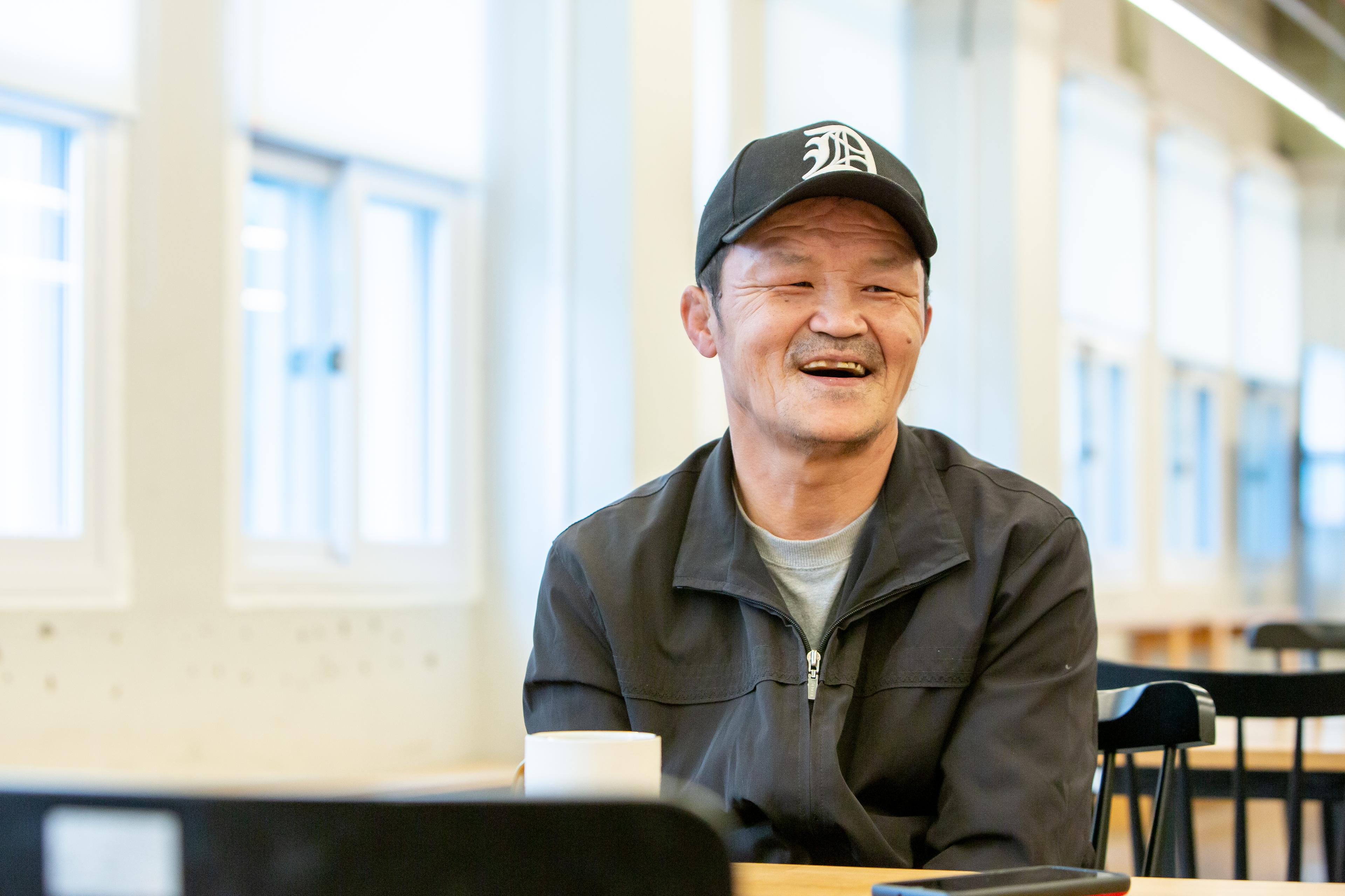 a man sitting at a table laughing