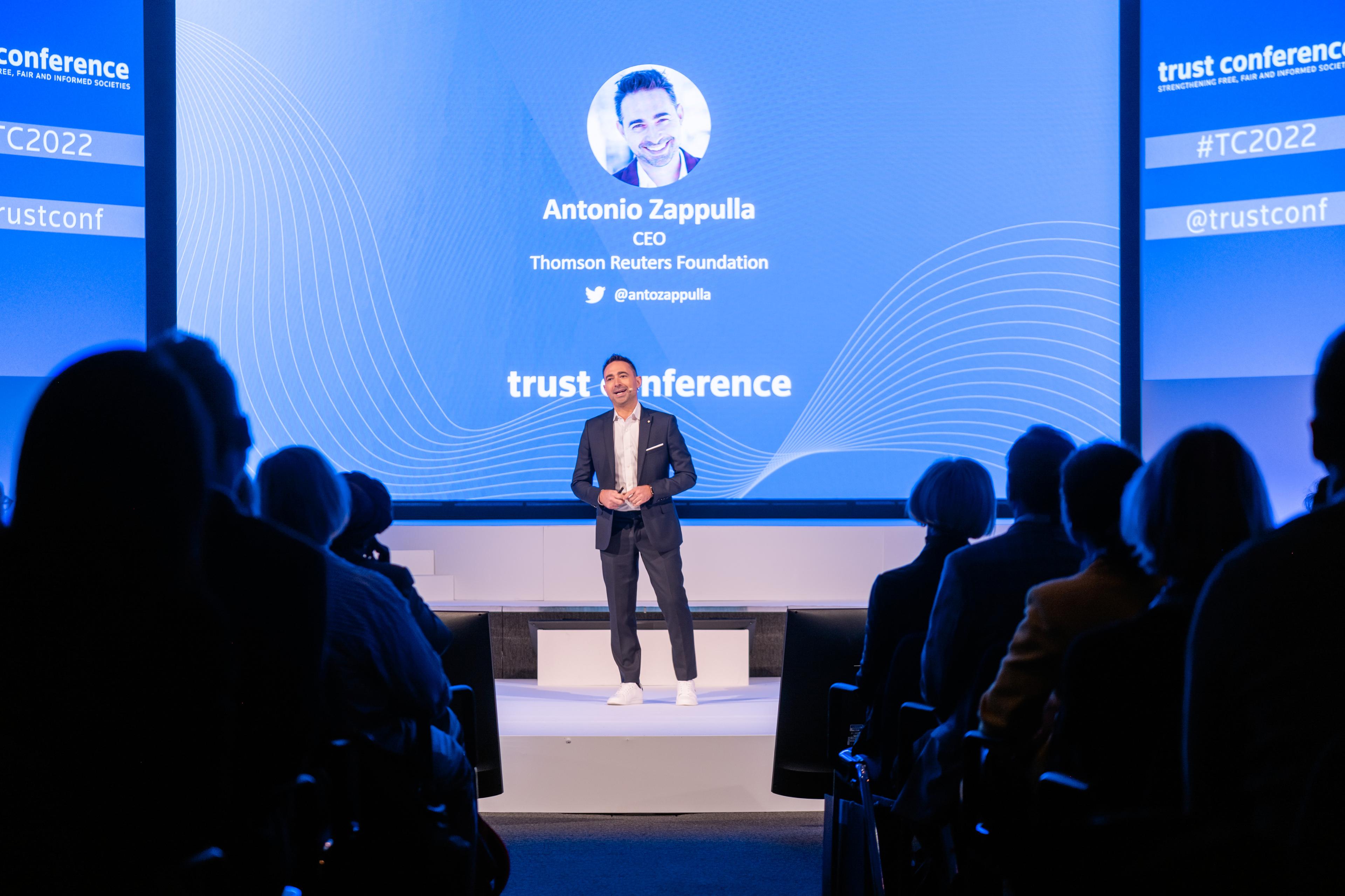 A man speaks from a stage at Trust Conference