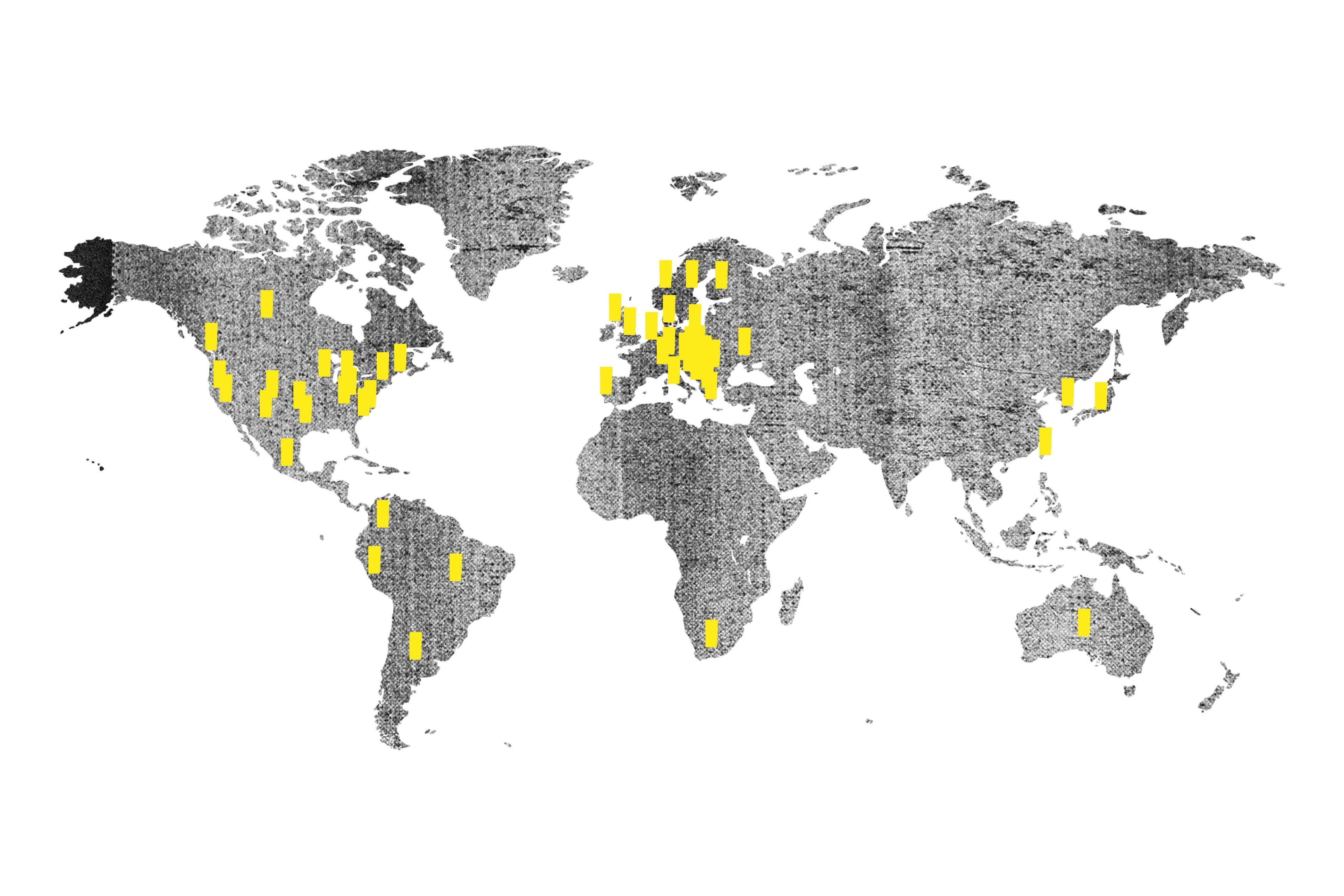 Grey world map with yellow pins showing location of street papers around the world 