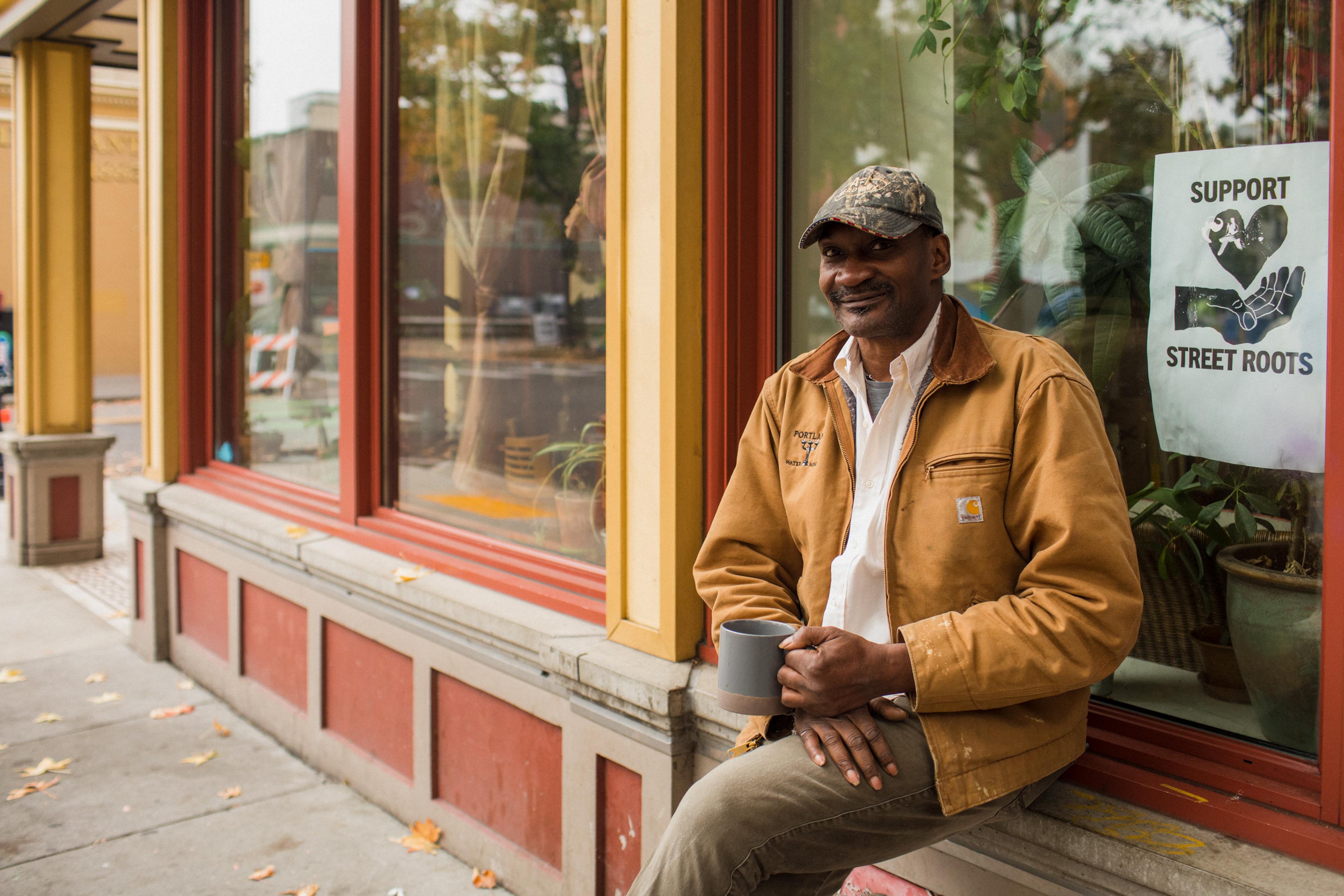 Man sitting on window ledge