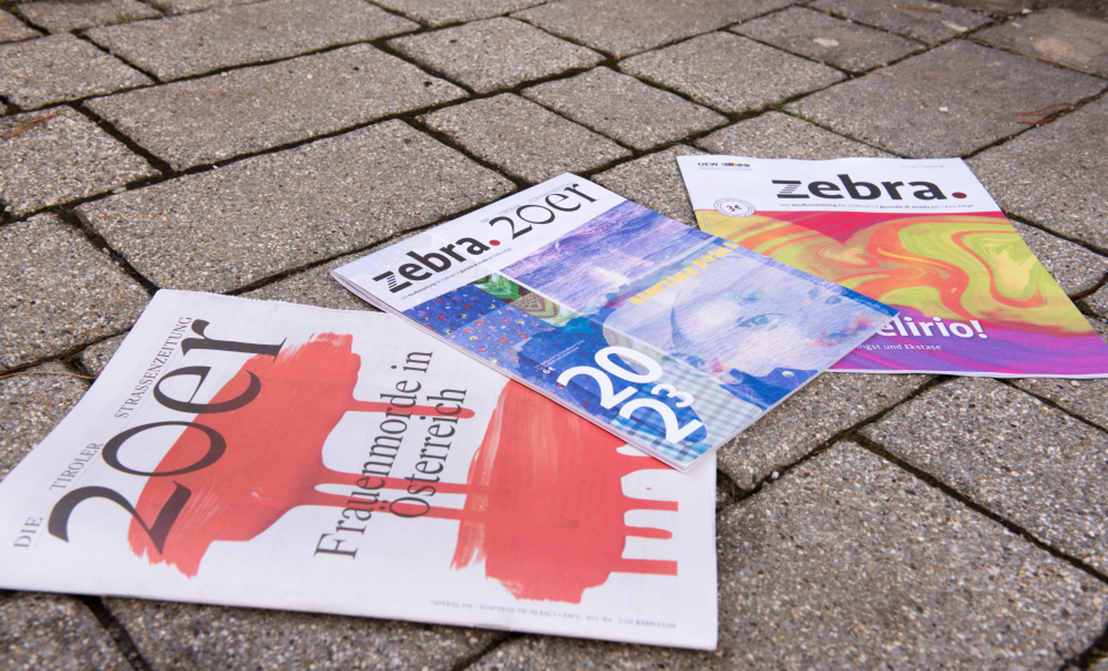 Copies of the street papers 20er and zebra. alongside their collaborative 2023 calendar