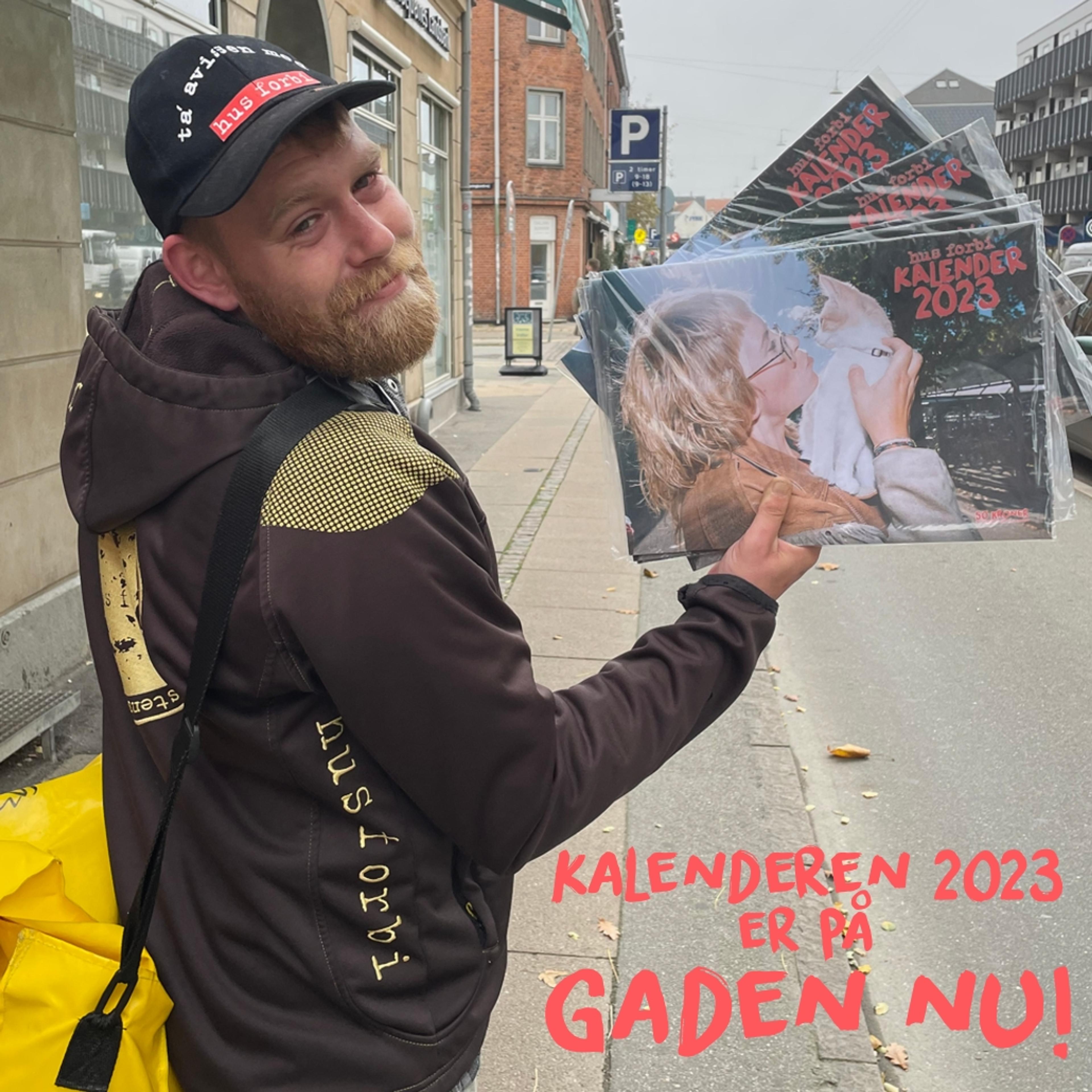 Hus Forbi vendor Tim holds the Danish street paper's 2023 calendar