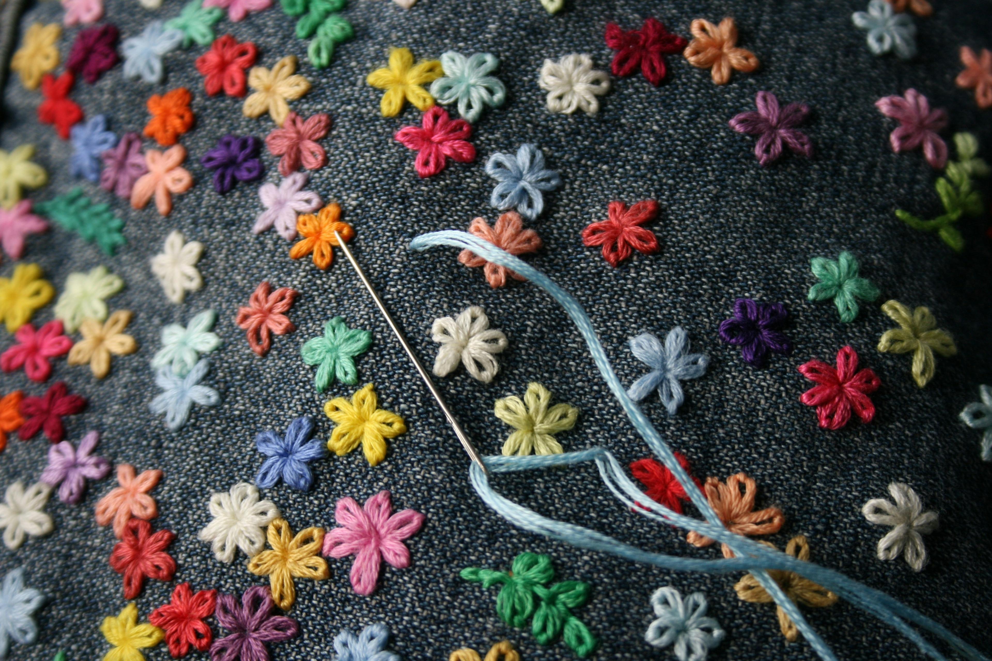 Colourful flowers embroidered into denim