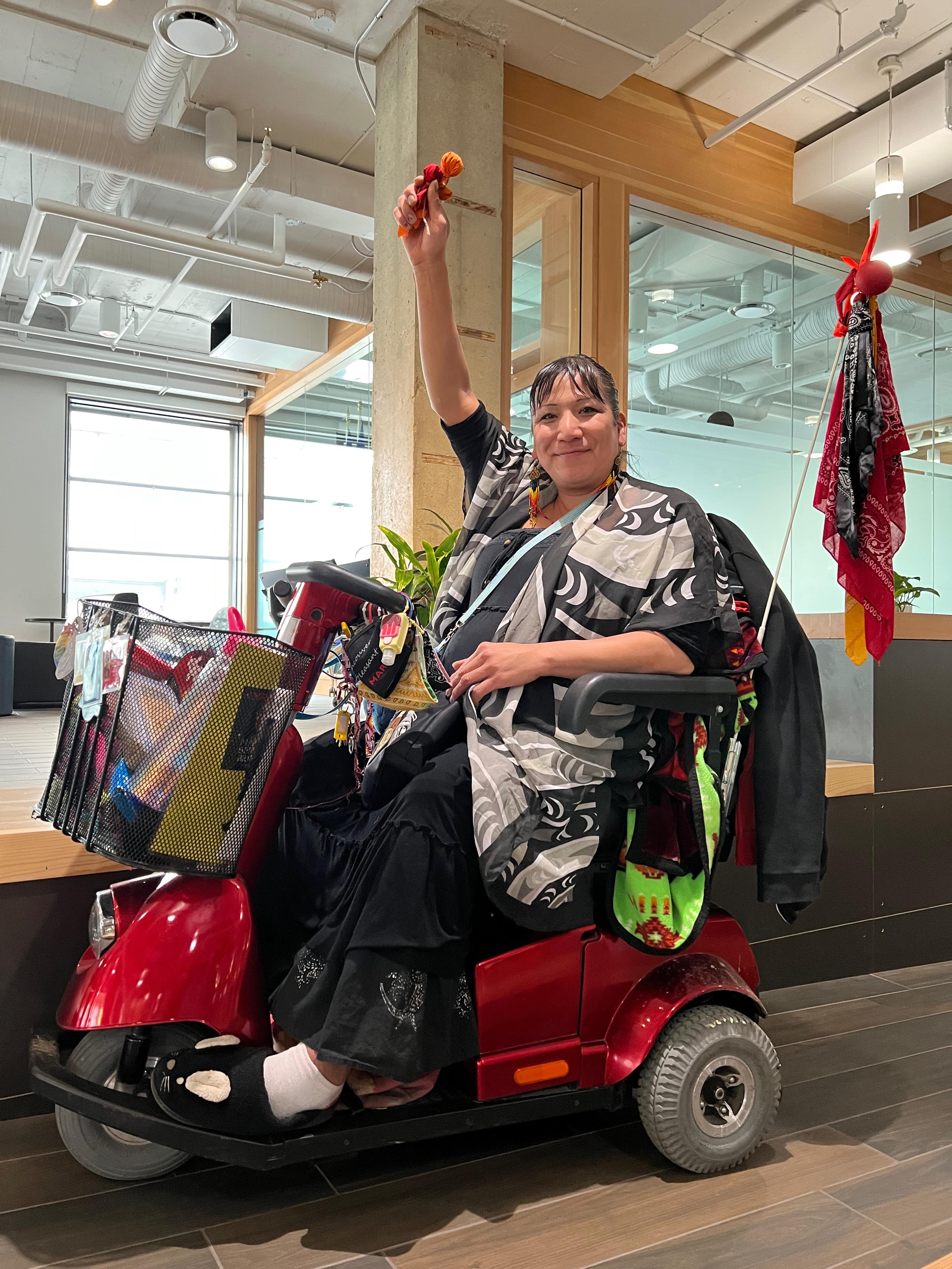 Suzanne Kilroy/Huculak sits on her mobility scooter