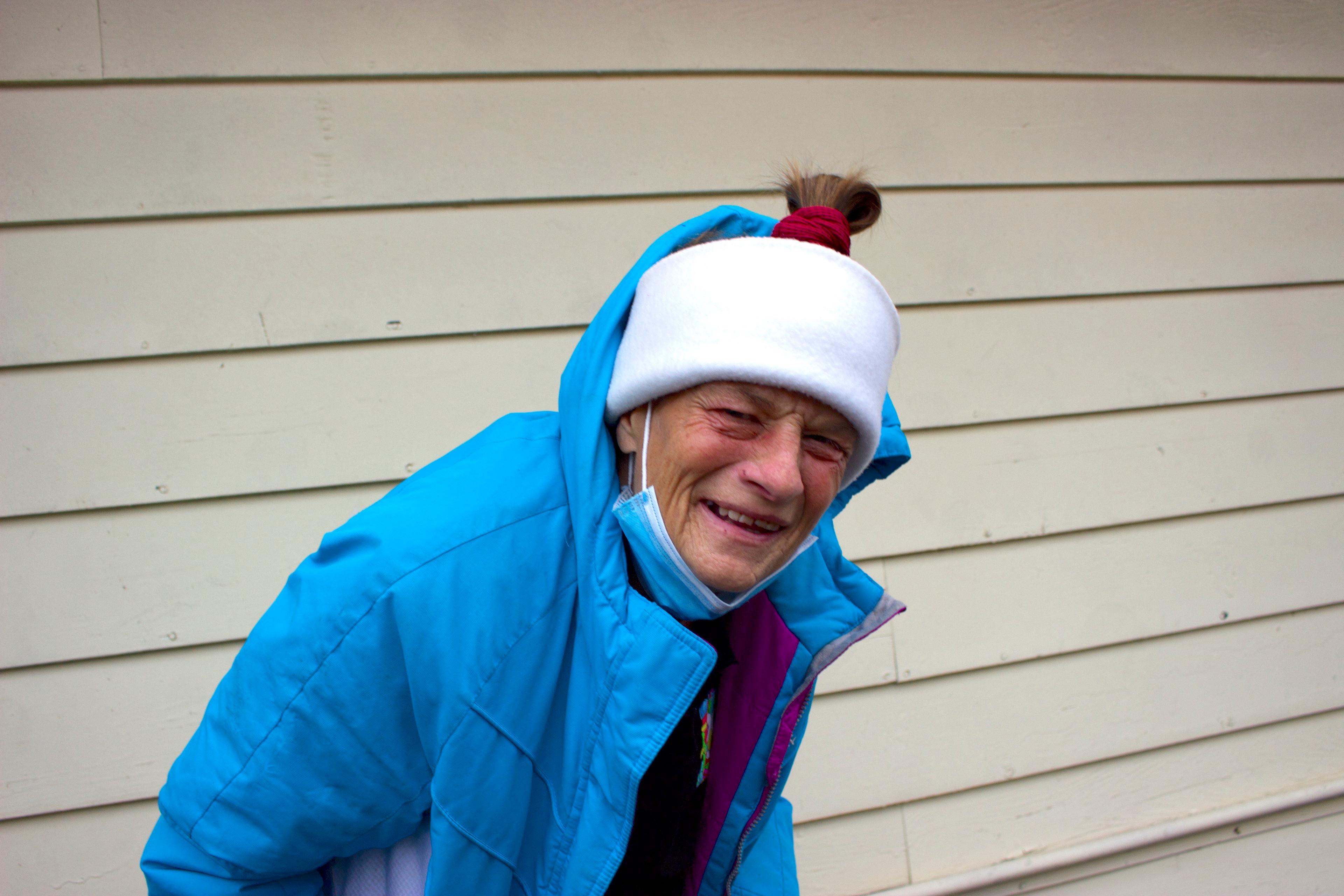 a woman in a blue jacket and white hat