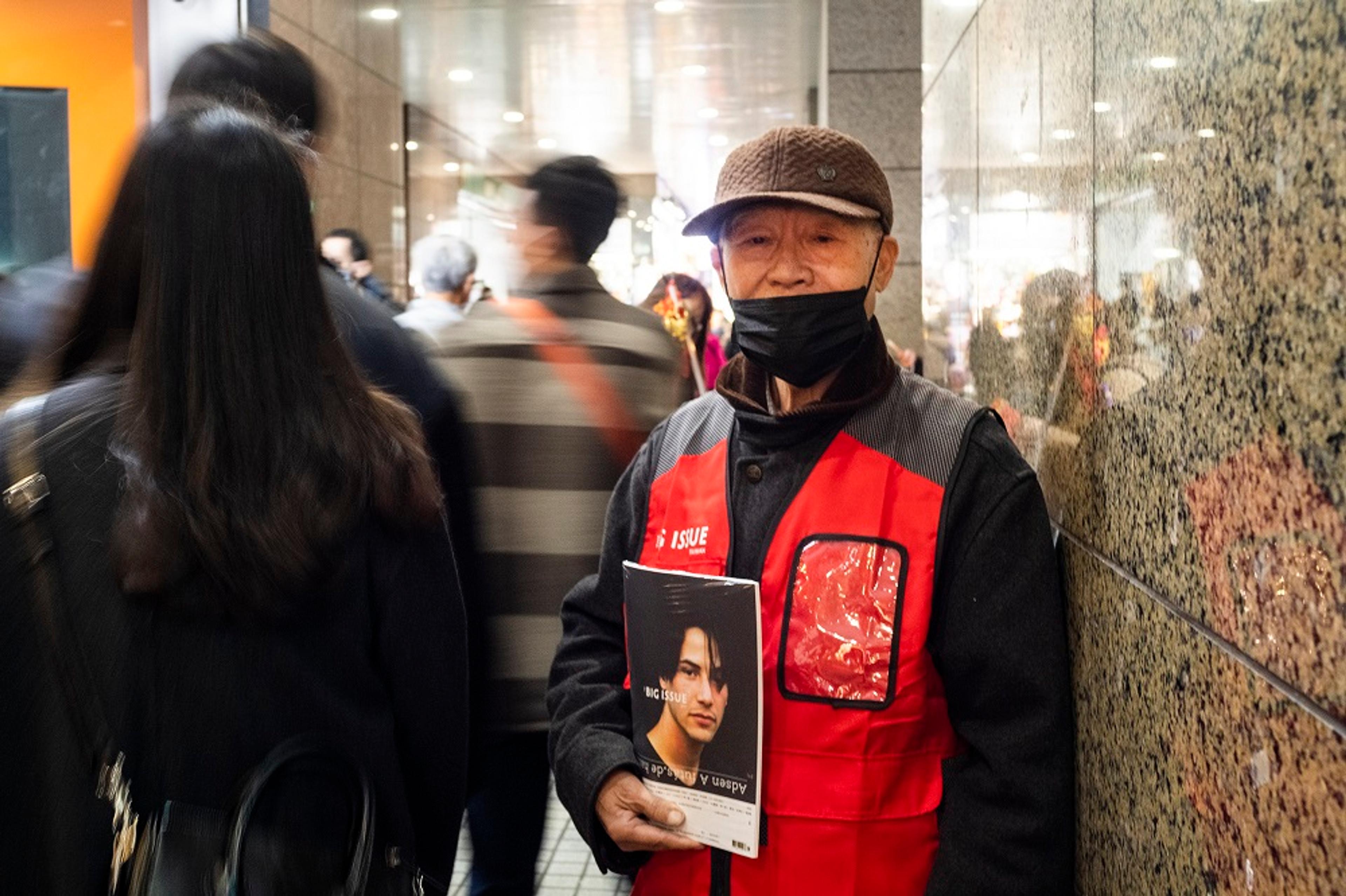 Man holding magazine in subway station