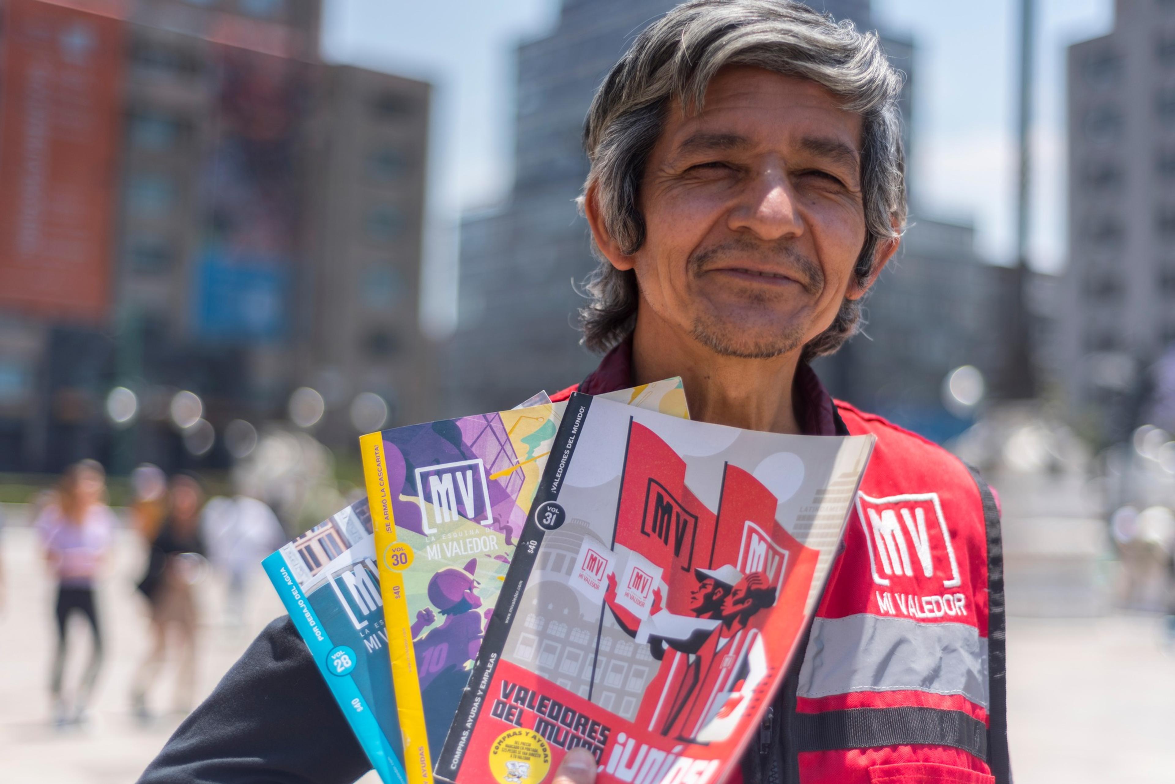 Man holding street paper in Mexico City