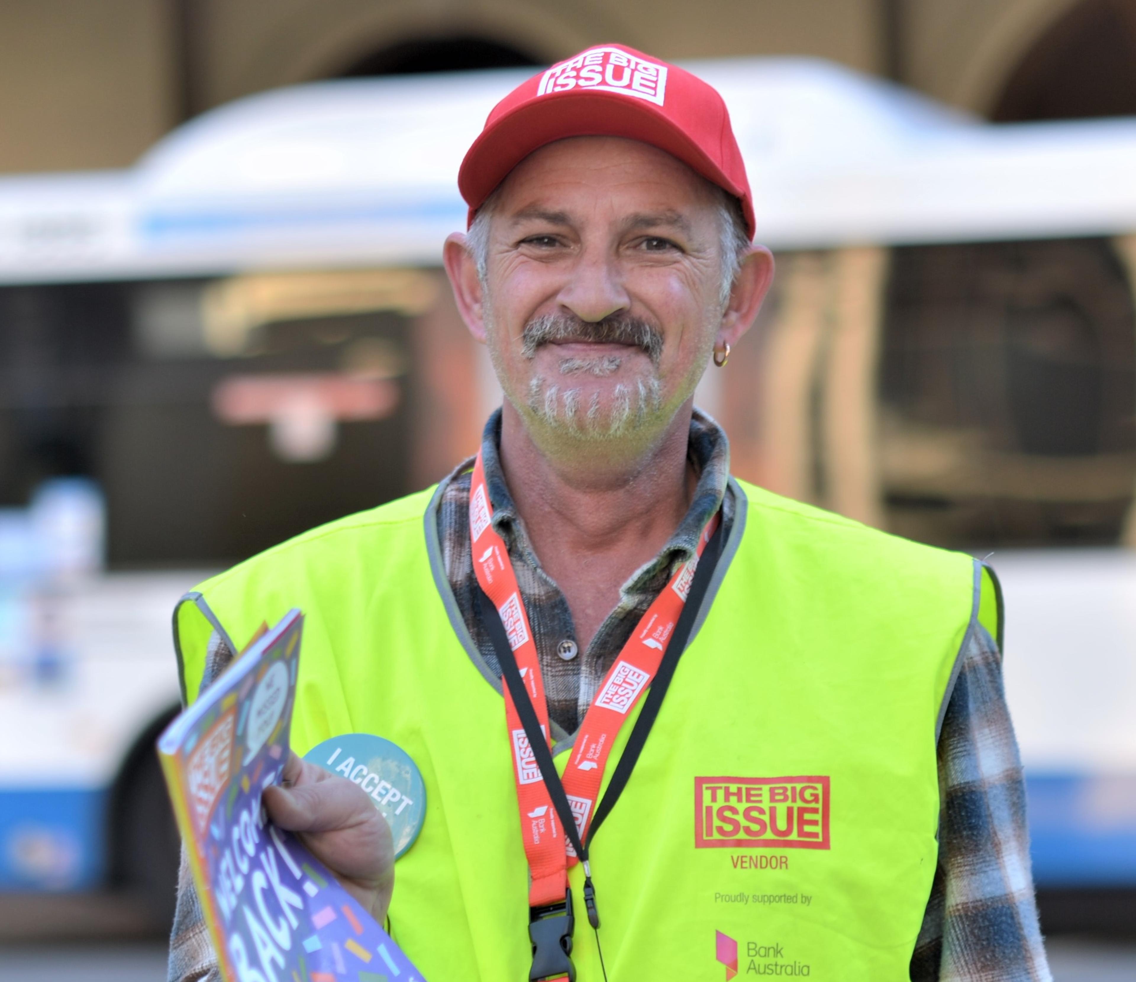 Man holding Big Issue Australia magazine