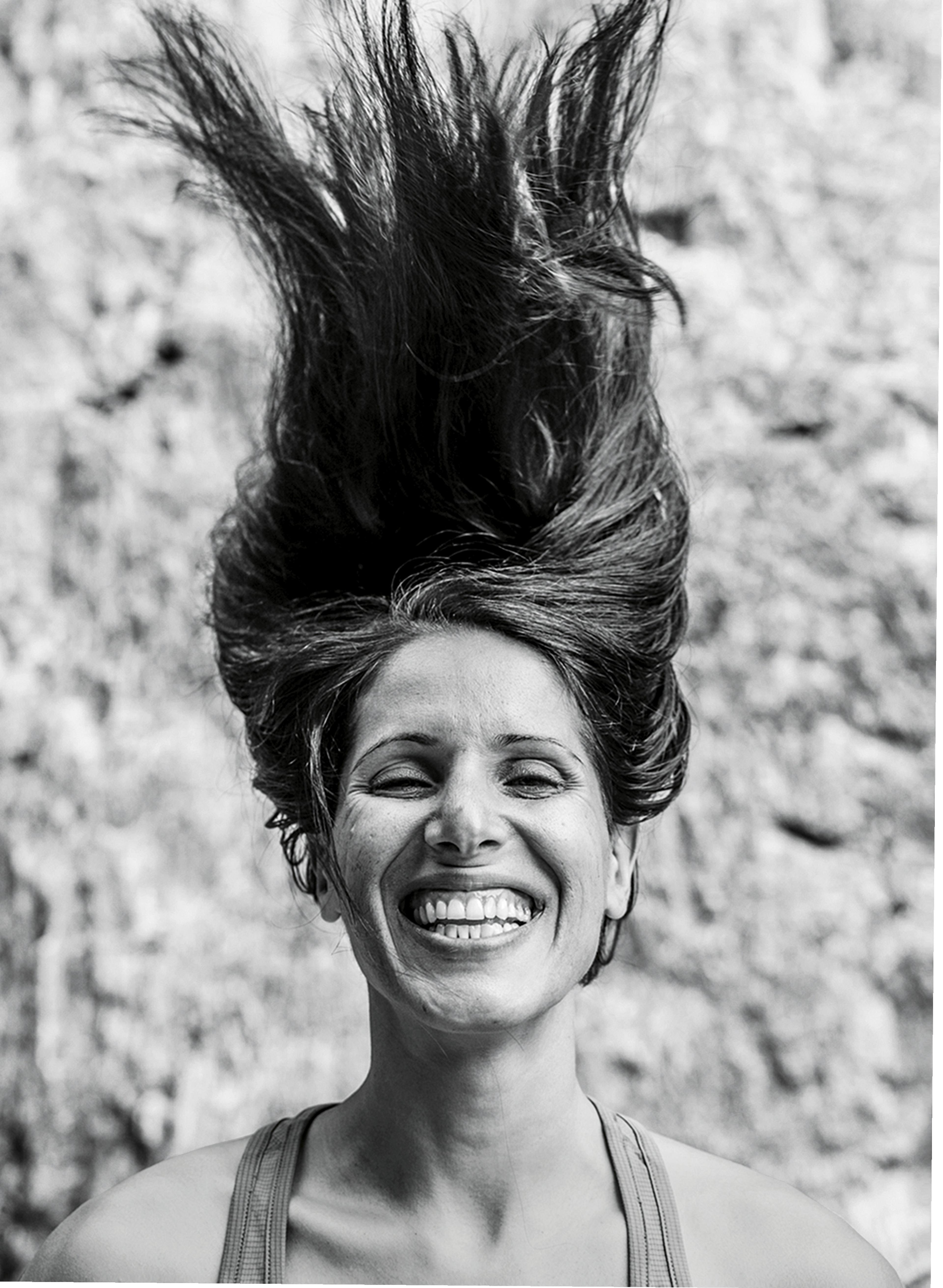 a black and white photo of Nasim hanging upside down