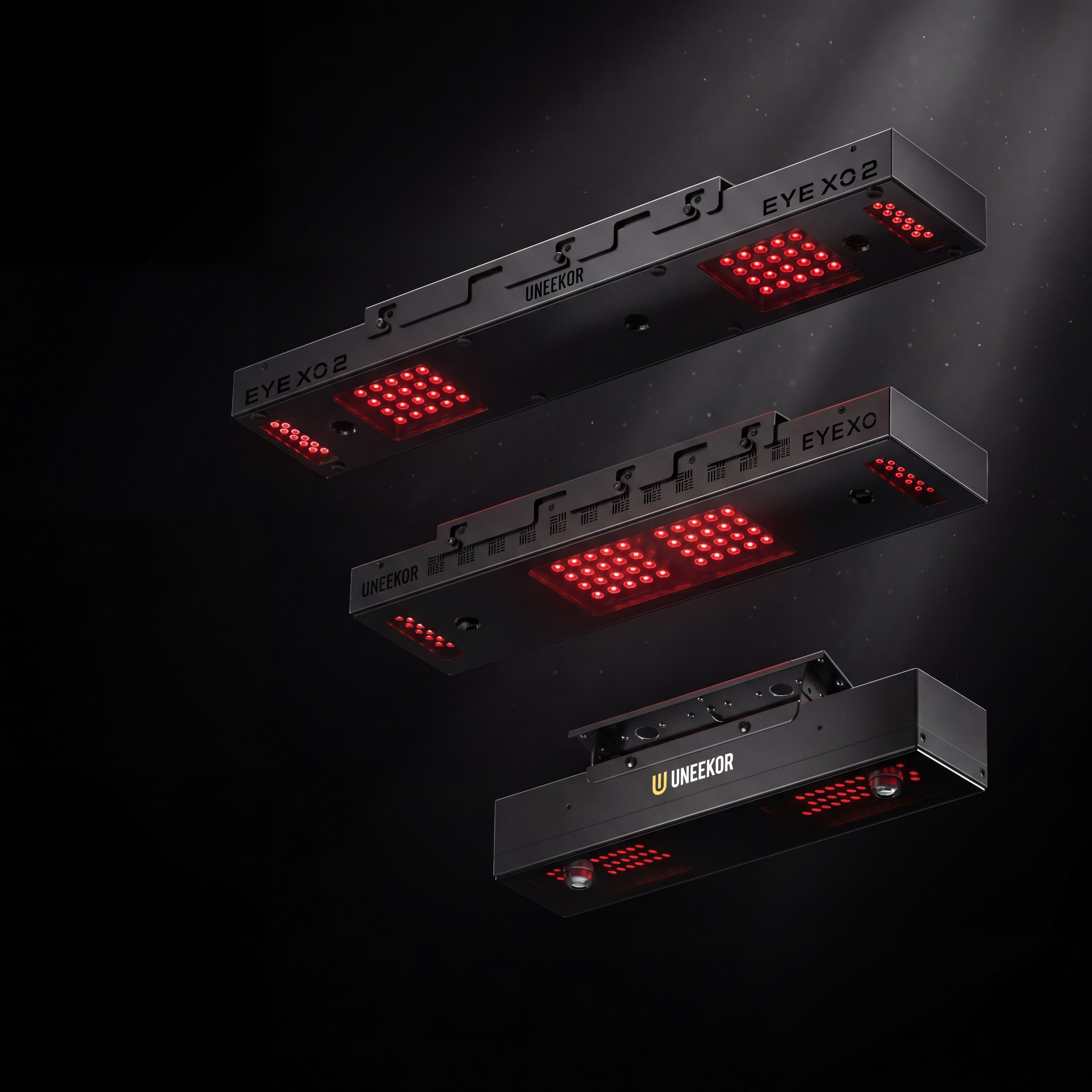 Three black Uneekor EYE XO golf simulator launch monitors with glowing red LEDs, stacked vertically on a dark background.