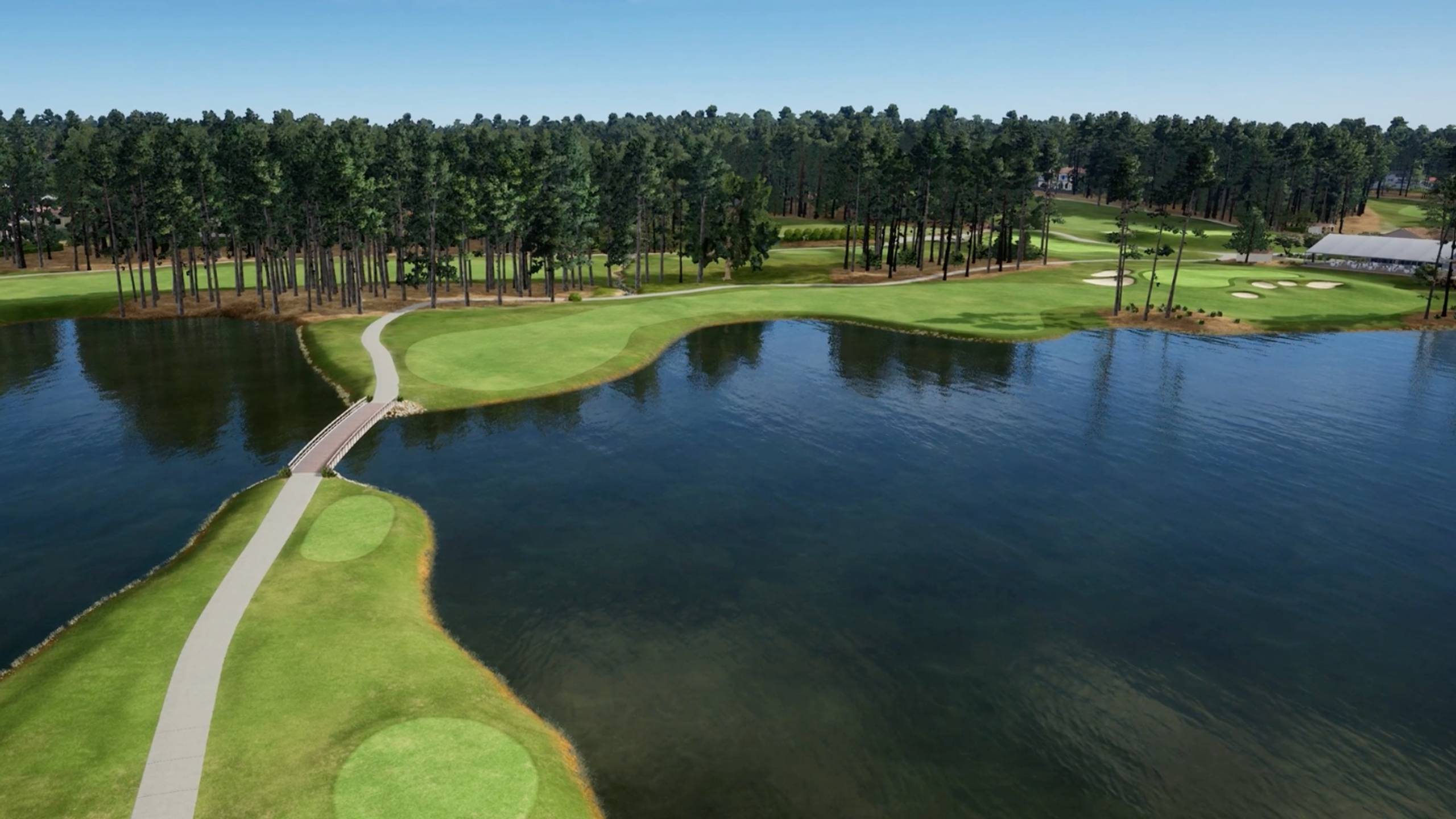 Aerial view of a MacGregor Downs Cary golf course featuring a bridge over a lake, surrounded by dense pine trees.