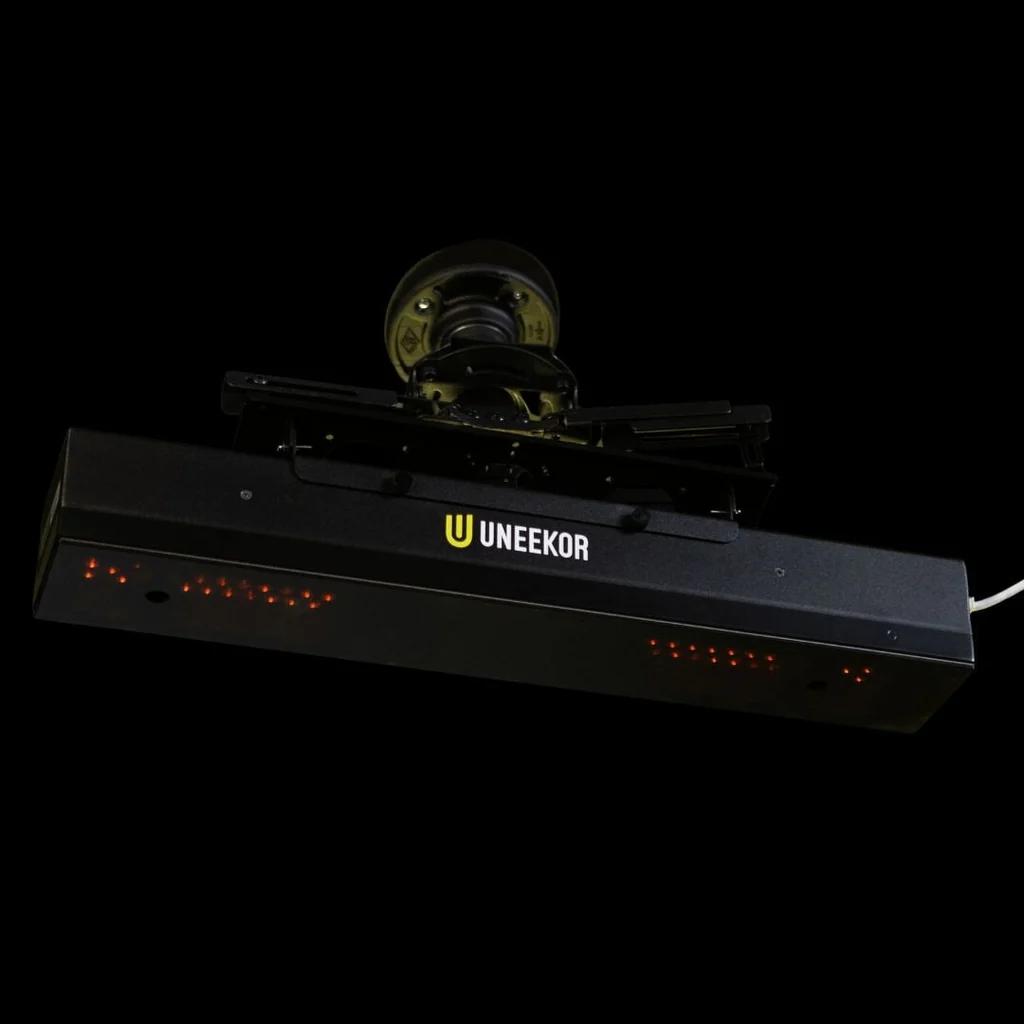 A black Uneekor golf launch monitor with red sensor lights.