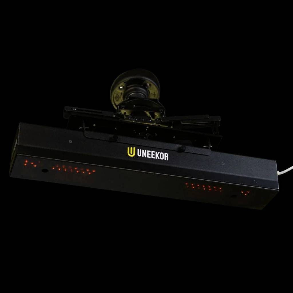 A black Uneekor golf launch monitor with red sensor lights.
