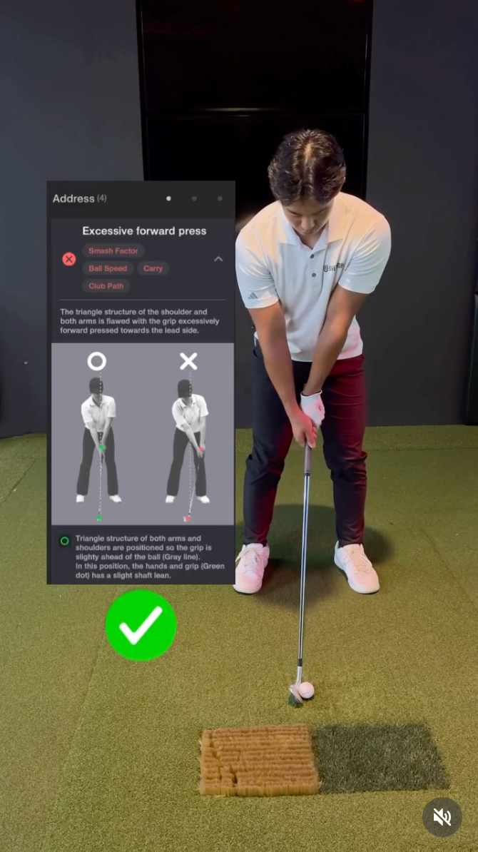 A golfer addresses a ball in a Uneekor Golf simulator, with a View software overlay displaying "Excessive forward press" golf swing analysis and a green checkmark indicating a good stance.