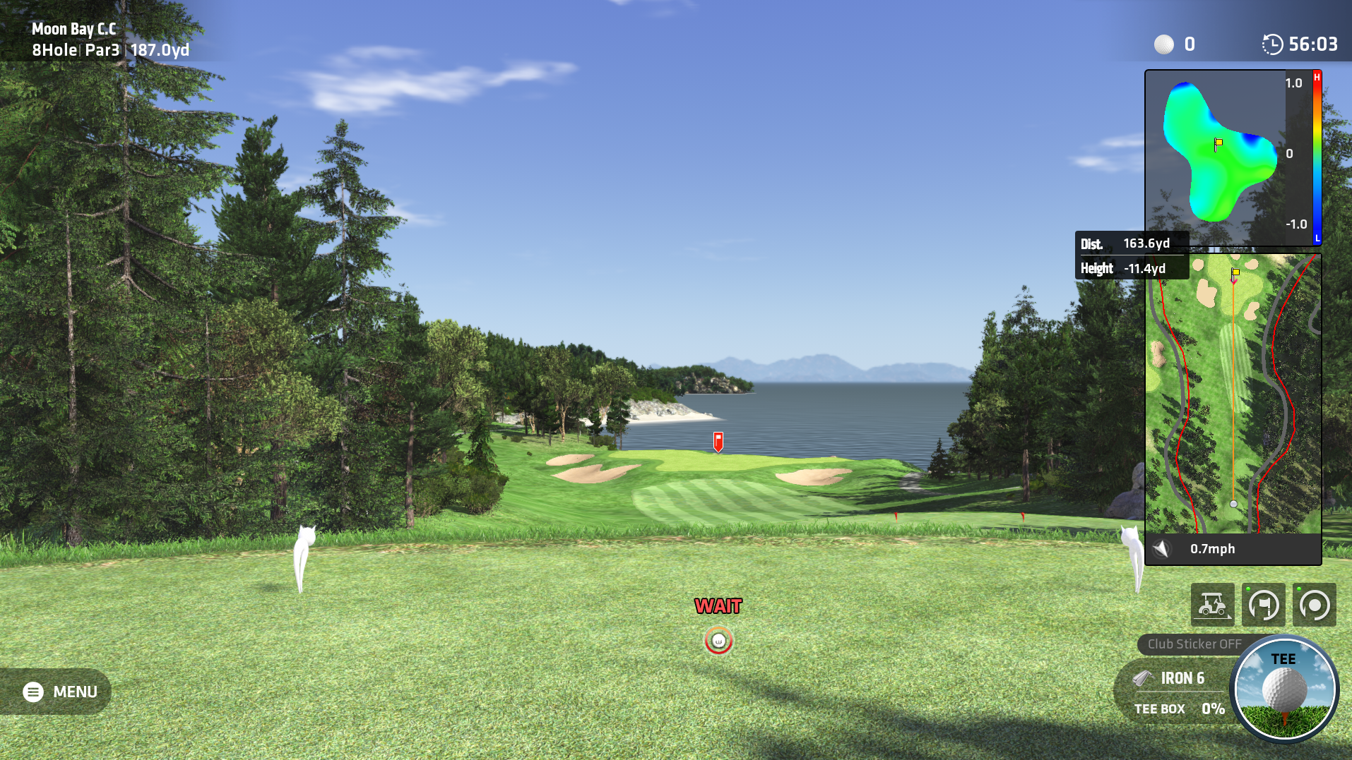 A golf video game screenshot from a tee box, overlooking a green towards a bay with distant land and a blue sky. The game interface shows distance, club selection (Iron 6), and a course minimap.
